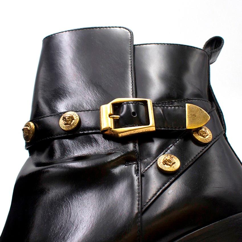 Versace Black Medusa Head Buckle Ankle Boots

- Almond toe
- Ankle boot
- Chunky block heel
- Smooth shiny black leather
- Leather pull tab at the back of the ankle
- Leather buckled strap around the ankle of the boot 
- Gold-tone metal buckle and