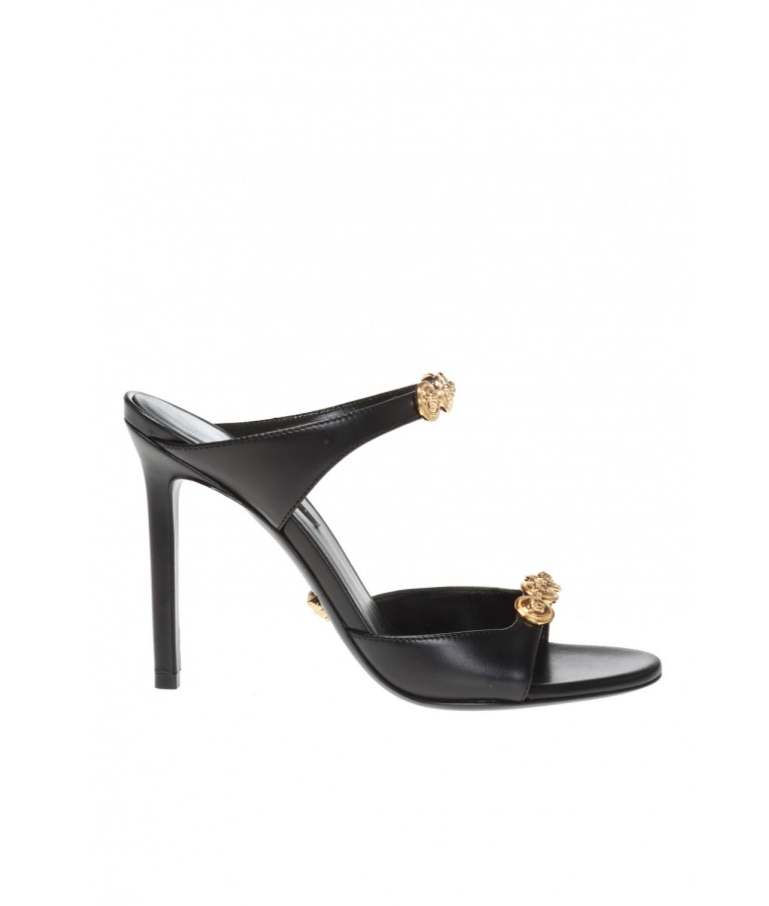 These Versace black stiletto mules feature calf leather and gold-tone Medusa medallions studded around the straps. Brand new and never owned, however they have been tried on by a client in store, leaving very minor dents in the sole. Made in