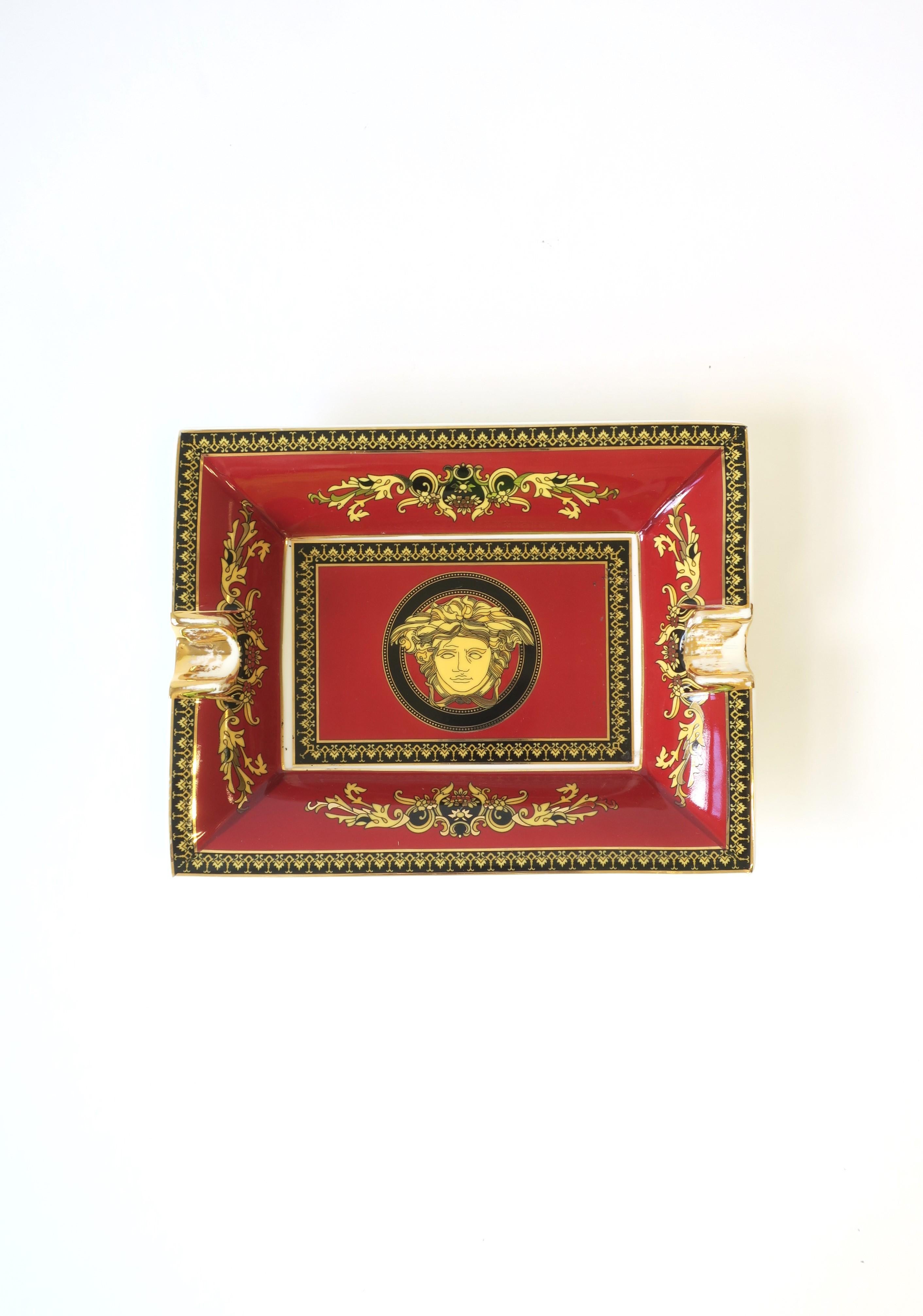 A 'Medusa' red burgundy and gold porcelain jewelry catchall tray dish vide-poche or ashtray from luxury Masion Versace, circa late-20th century. This porcelain tray is made by Rosenthal, Germany, for Versace, Italy, featuring the House of Versace’s