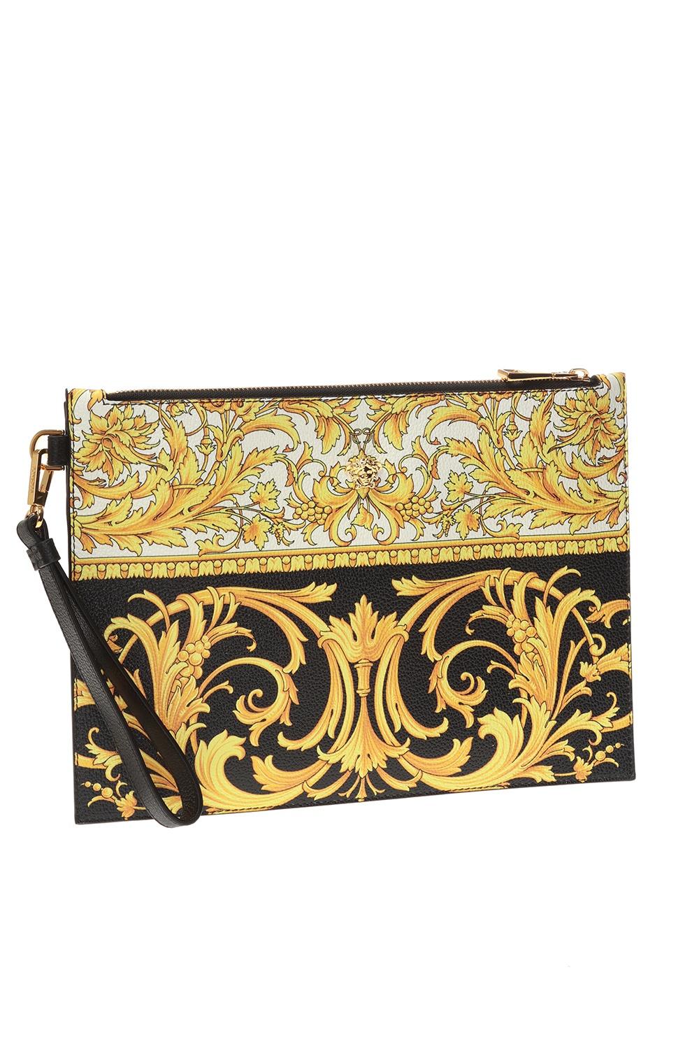 Versace Mens Barocco Print Leather Zipper Pouch with Detachable Wrist Strap

Go bold in baroque. Crafted in leather, this black, white and gold-tone baroque print clutch / pouch from Versace sports a sleek, streamlined design. Finished with a