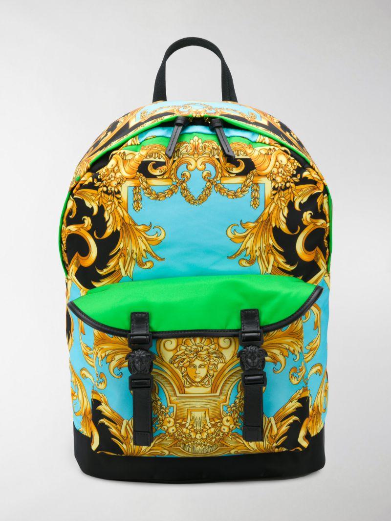 Green, blue and black Homme De Barocco print mens backpack from Versace. Fastened with zip. Finished with leather. Embellished with a baroque print throughout. It features frontal pocket fastened via medusa buckles, a half-round handle, adjustable