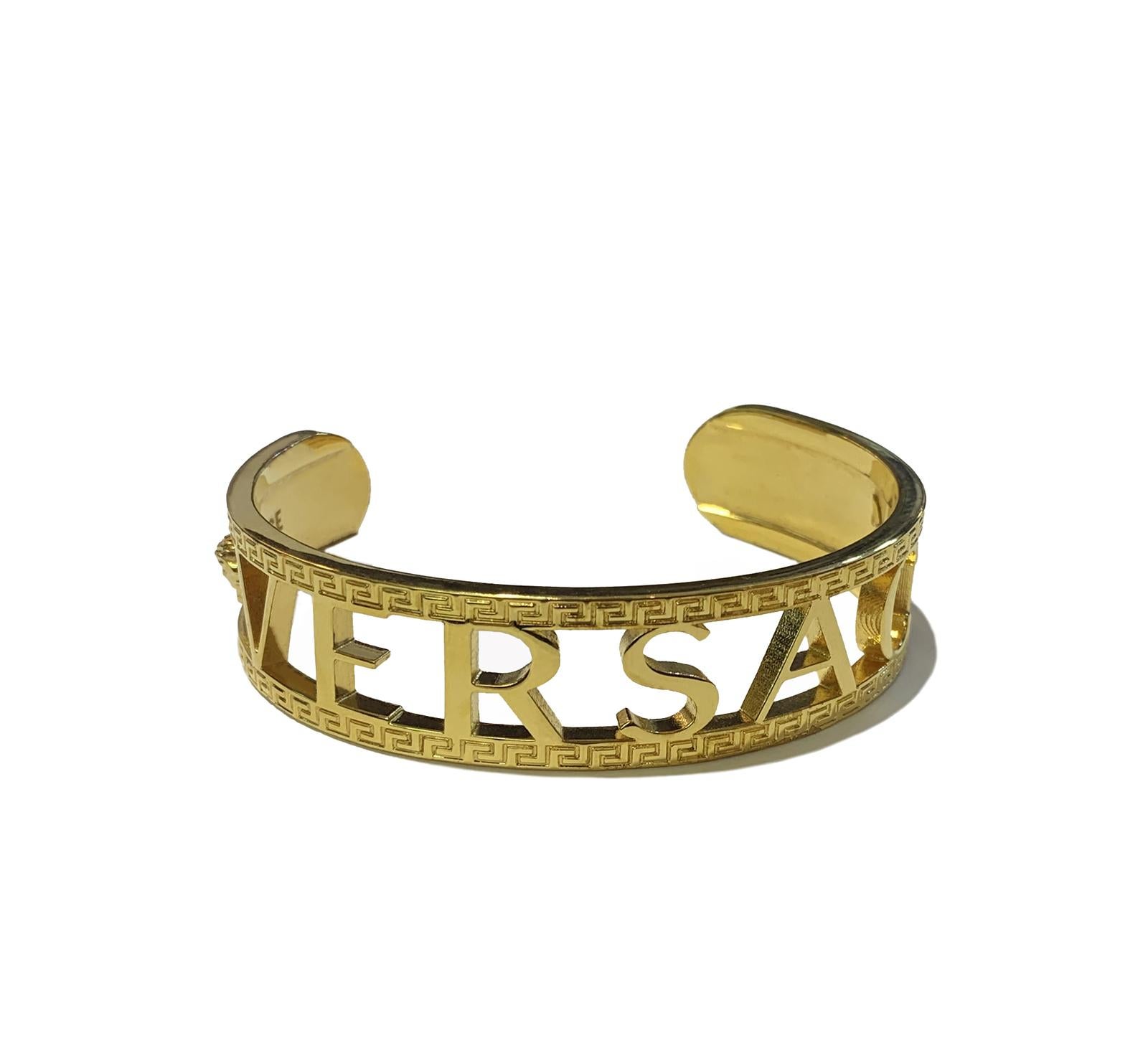 VERSACE MENS LOGO/GREEK KEY CUFF BRACELET.

-Display model. Good condition
-Open cuff bracelet in gold-tone
-Engraved Greek key pattern and logo throughout
-Signature Medusa engraved at face
-Logo engraved at inner band
-Approx. 2.5” diameter
-Inner