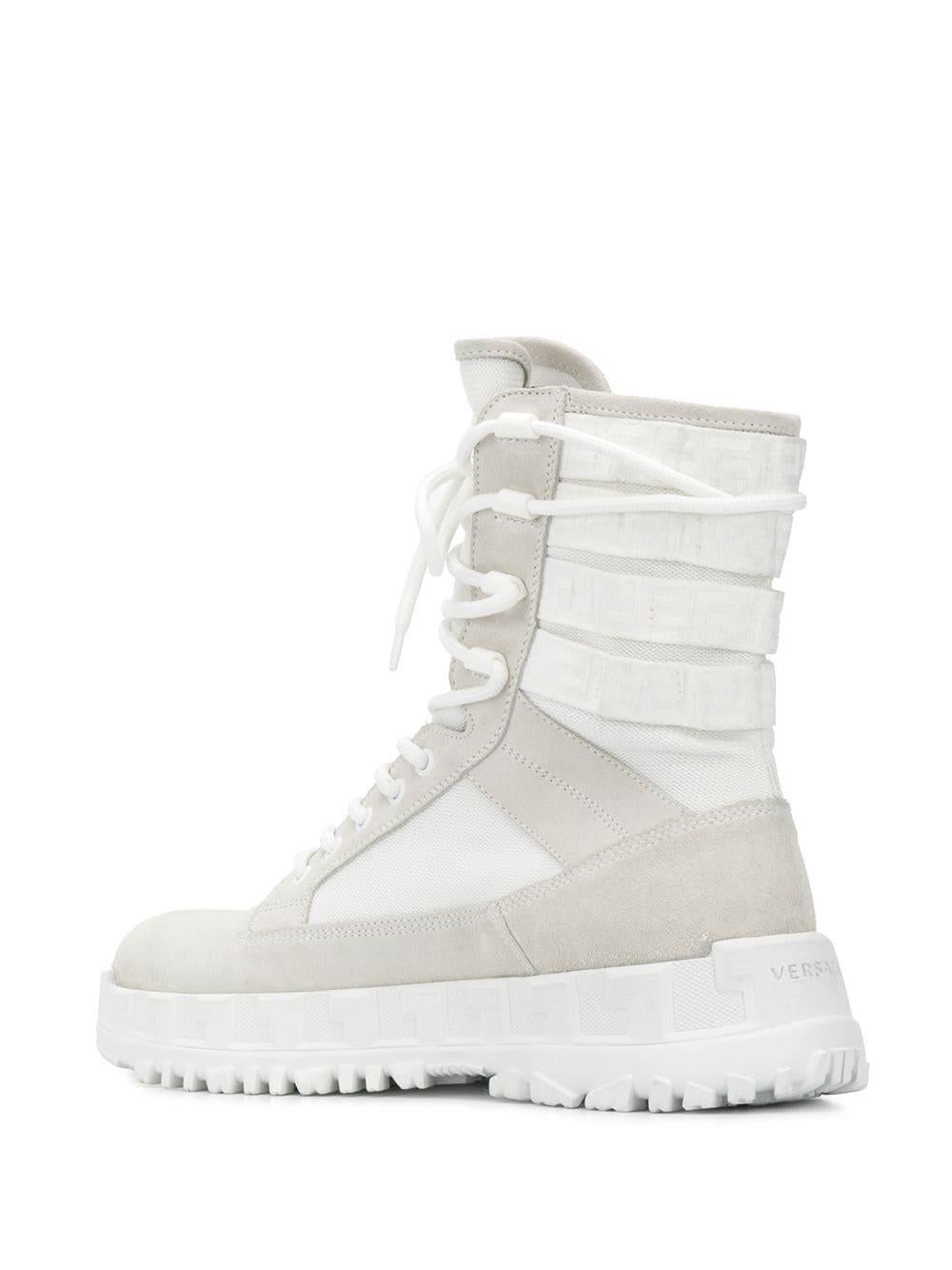 Versace Mens SS20 Runway White Mid-Calf Lace-Up Combat Boot / Sneakers

Debuting on the Spring-Summer 2020 runway, the Greca Rhegis combat boots are not your average shoes.  With a mid-calf length, they have a strappy detail on the back,