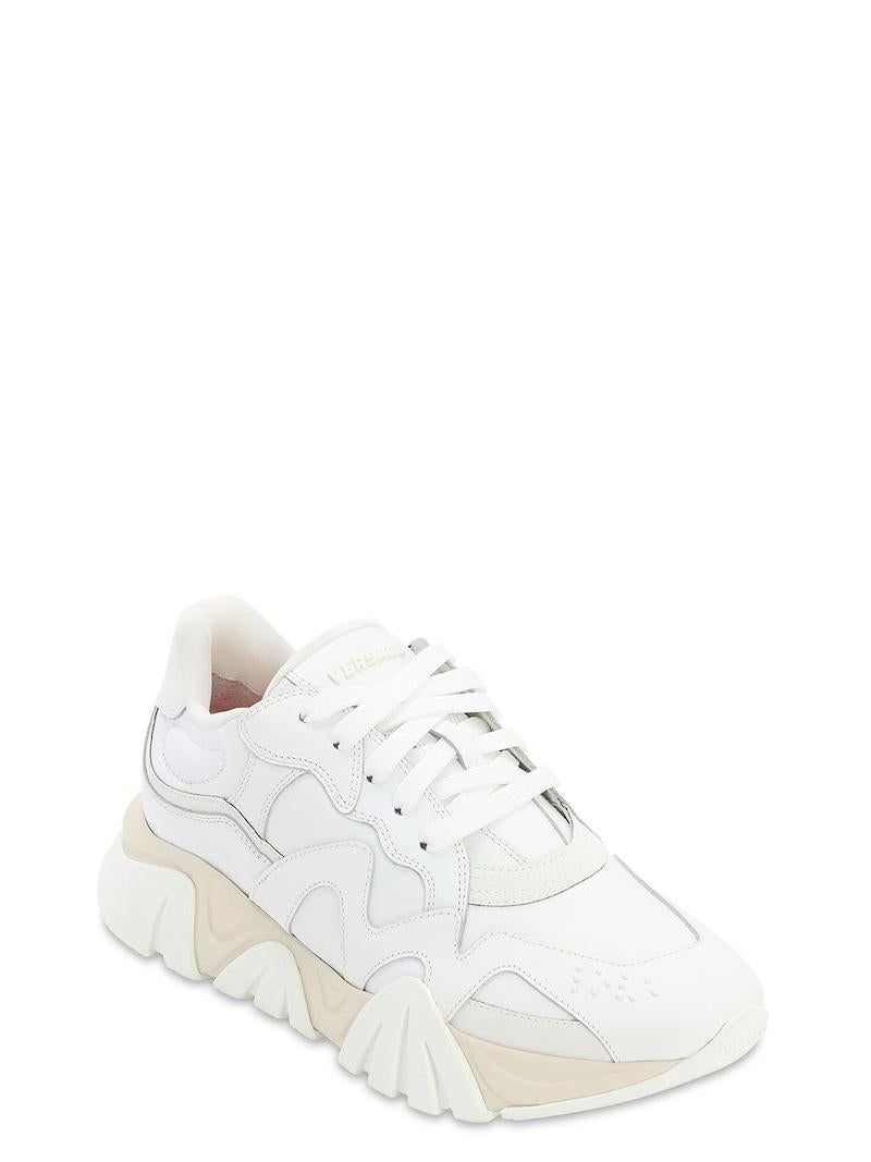 Versace Mens White and Beige Leather/Canvas Squalo Sneakers

These Versace leather shoes are perfect for setting a style trend on your casual outings. Featuring paneled designs on the surface, the squalo platform sneakers come with lace tie-ups that