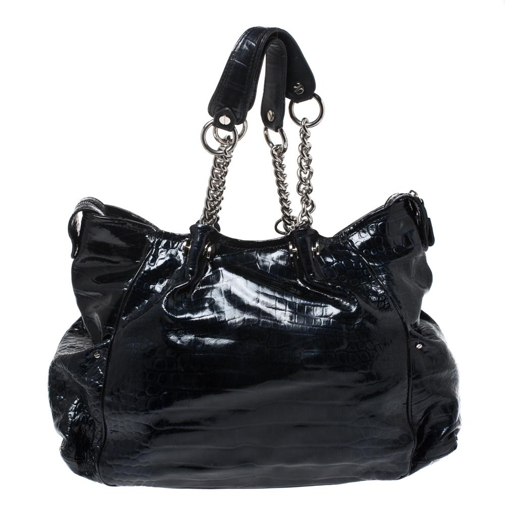 Designed to last, this beautiful tote from Versace is a prized buy. Comfortable and easy to carry, this croc-embossed patent leather creation comes in blue with a logo charm on the front. It has twin chain handles and an interior lined with satin to