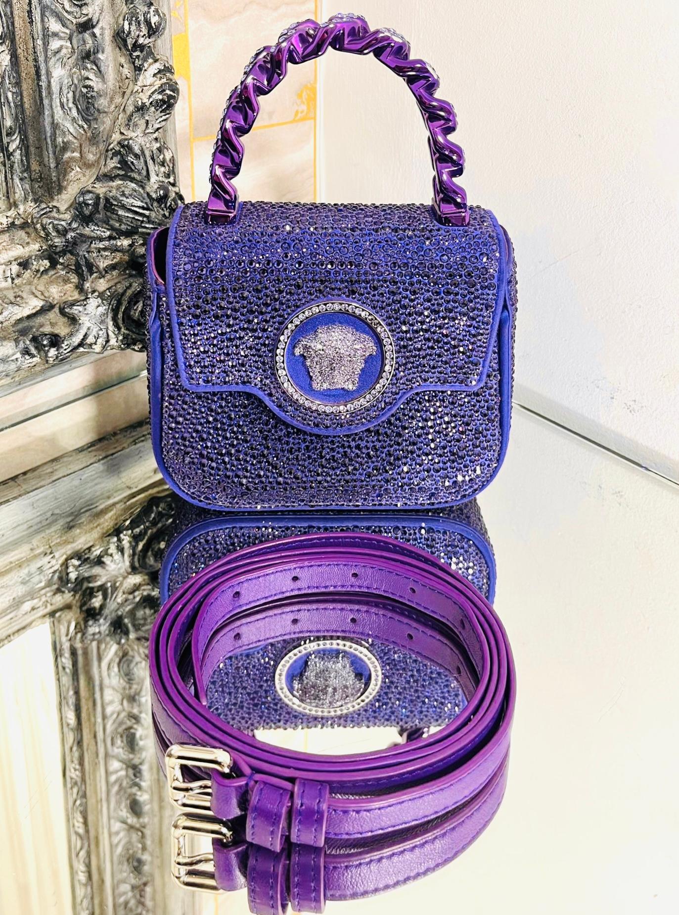 Versace Mini Crystal Studded Medusa Bag

Purple top handle carry hand bag with cross body leather strap.

Fully adorned with crystal embellishment throughout. Signature crystal Medusa

head to the centre. Featuring solid metallic purple chunky chain