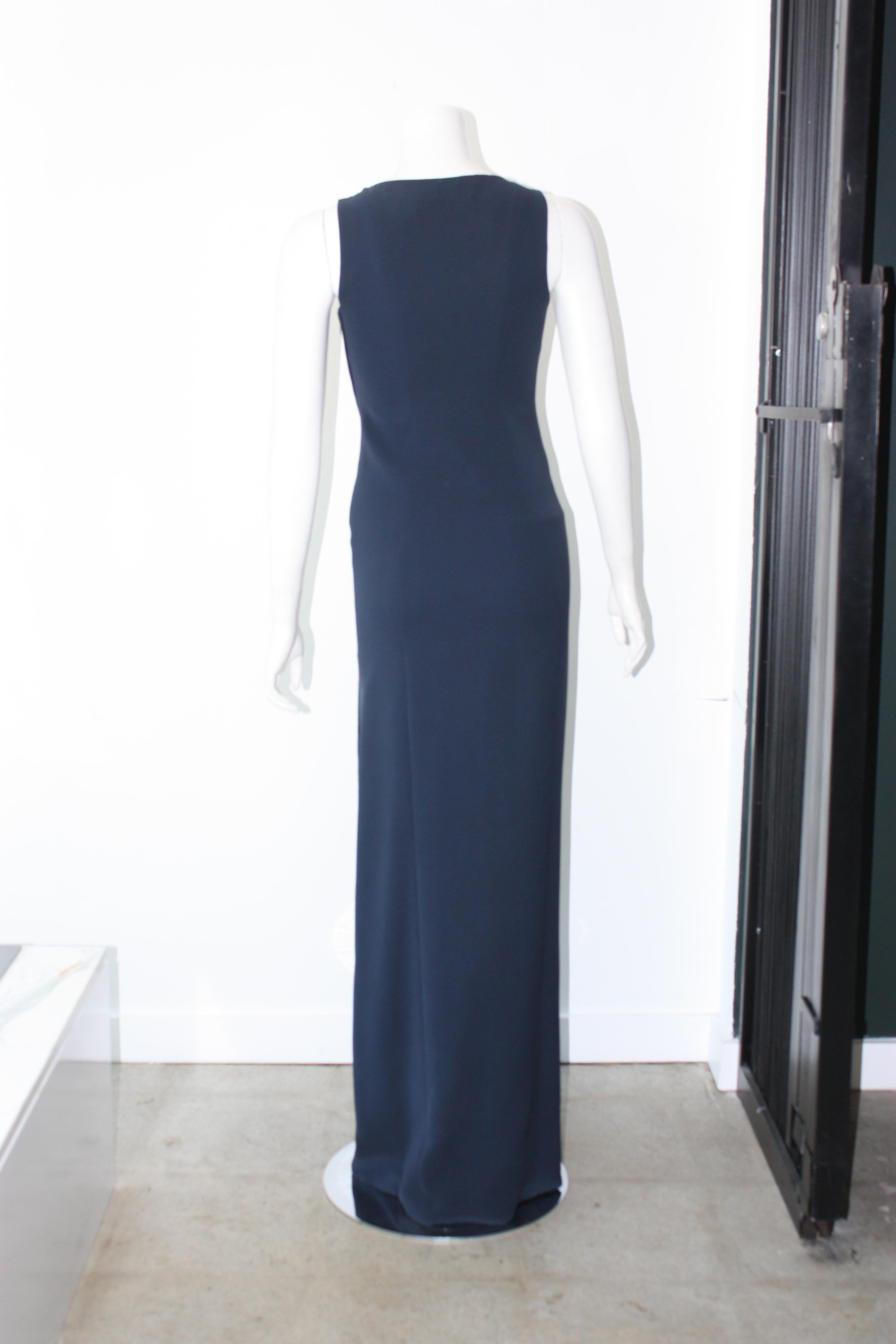Versace navy evening gown with contrasting silk cowl neck chest and navy blue beads down the side. Side leg zipper.

Size 38
Silk, acetate, viscose bend