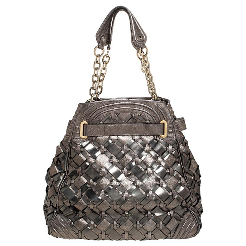 This stunning shoulder bag by Versace makes a statement. It is crafted in Italy and is made from PVC and leather. It comes in a stunning shade of olive green and has a sheen as well. The exterior of the bag is beautified with woven detailing. The