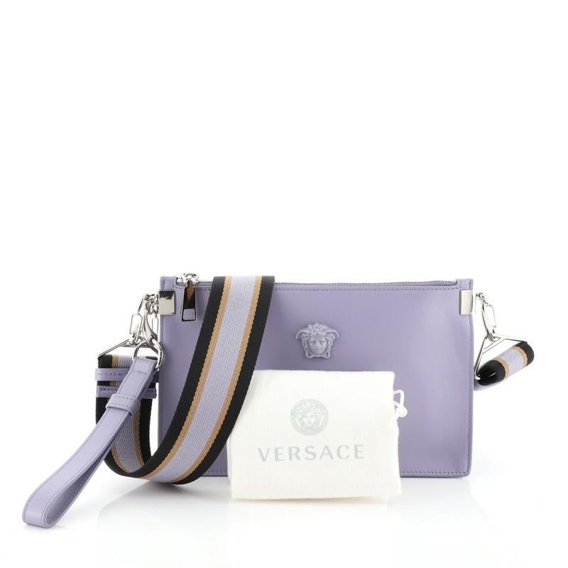 This Versace Palazzo Crossbody Pouch Leather Medium, crafted from purple leather, features an adjustable strap, Medusa head logo and silver-tone hardware. Its zip closure opens to a black fabric interior with slip pocket. 

Estimated Retail Price: