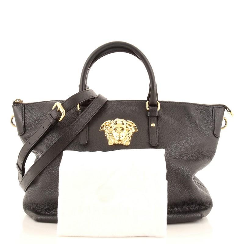 Condition: Fair. Odor in interior. Wear on base corners, handles and in interior, loss of shape and marks on exterior, creasing and wear on strap. Moderate cracking on handle, opening and strap wax edges, scratches, tarnish and heavy discoloration