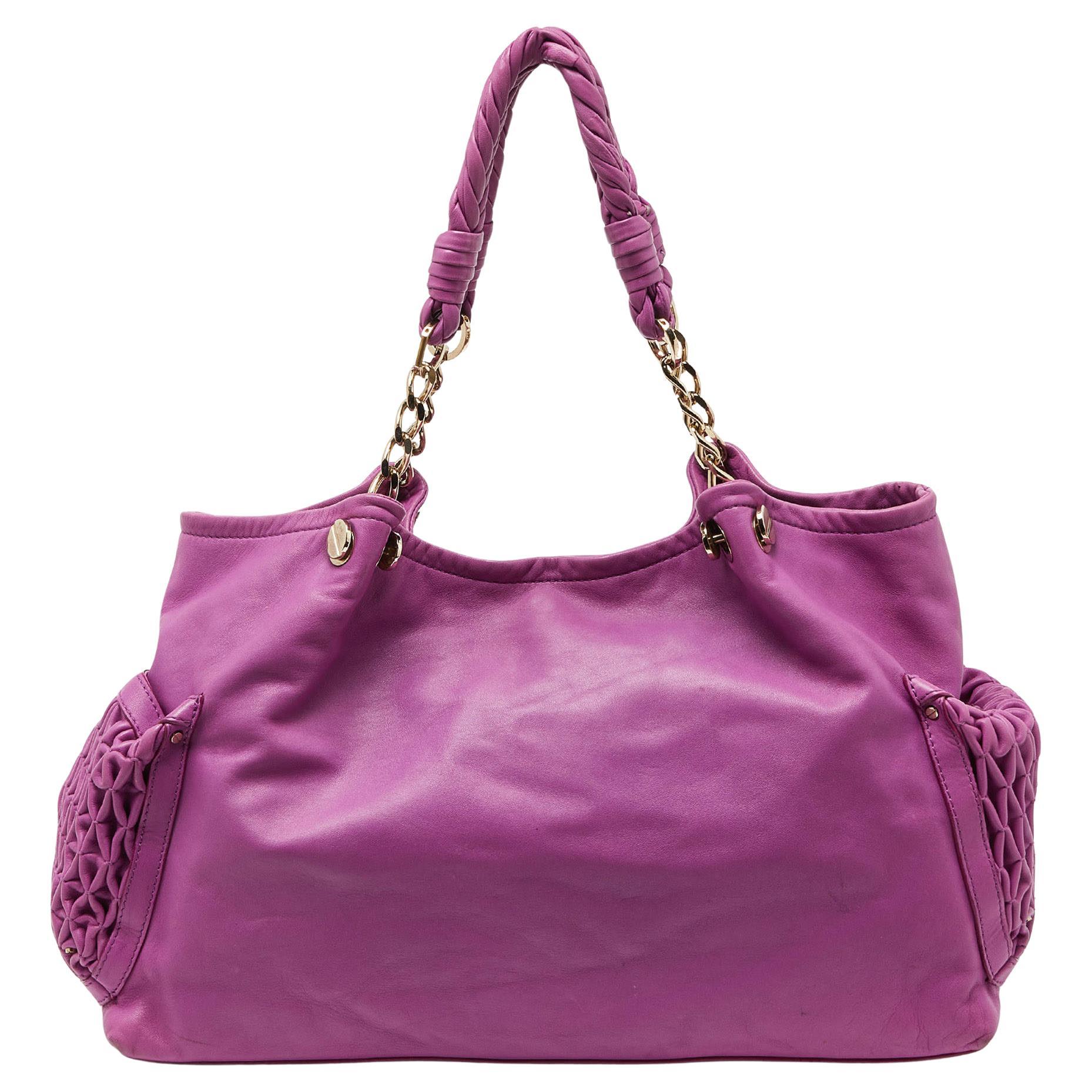 The satchel from Versace is made from leather. It comes with two handles, gold-tone hardware, and the brand signature detailing on the front. It is lined with satin and will easily hold your necessities.

