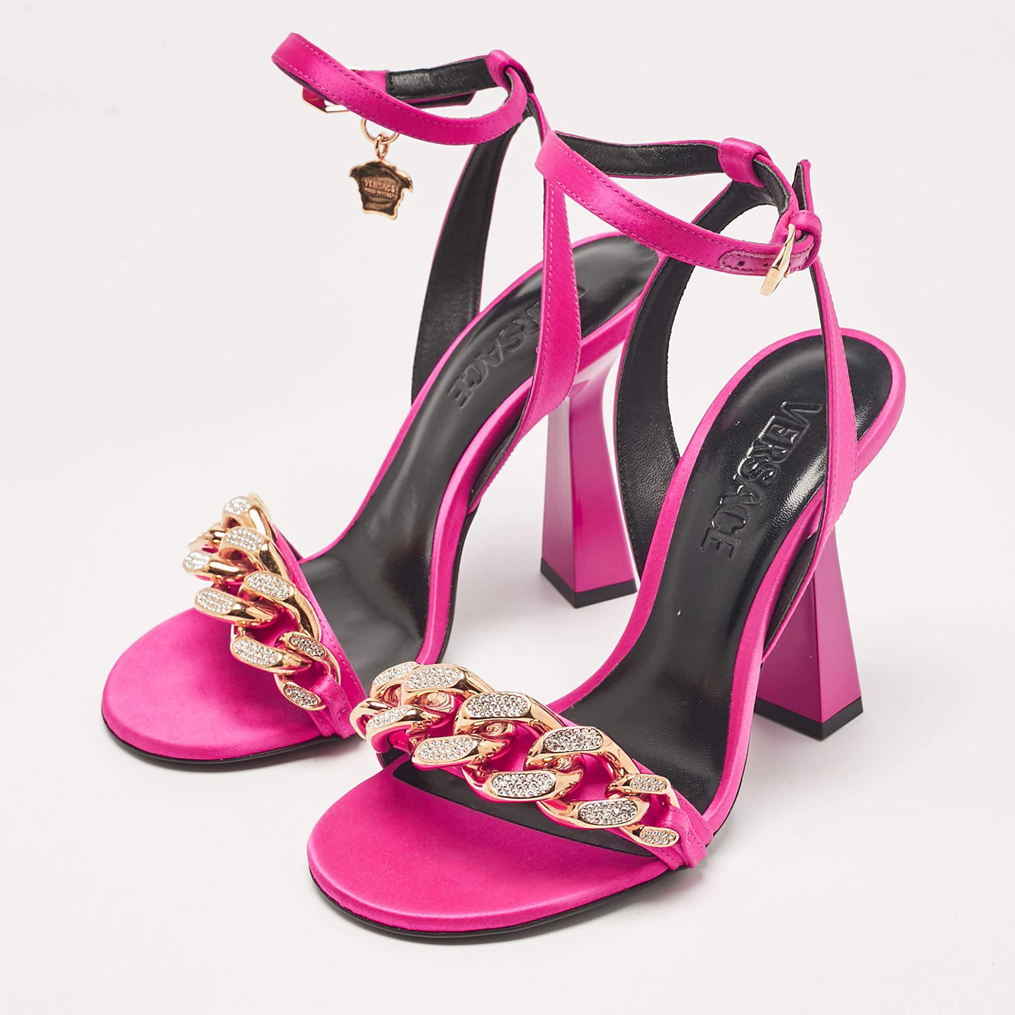 Versaces sandals combine glamour with edge. Featuring sleek satin a striking Medusa chain detail and ankle straps for a secure fit these sandals exude signature opulence. Perfect for making a bold statement they pair effortlessly with evening or