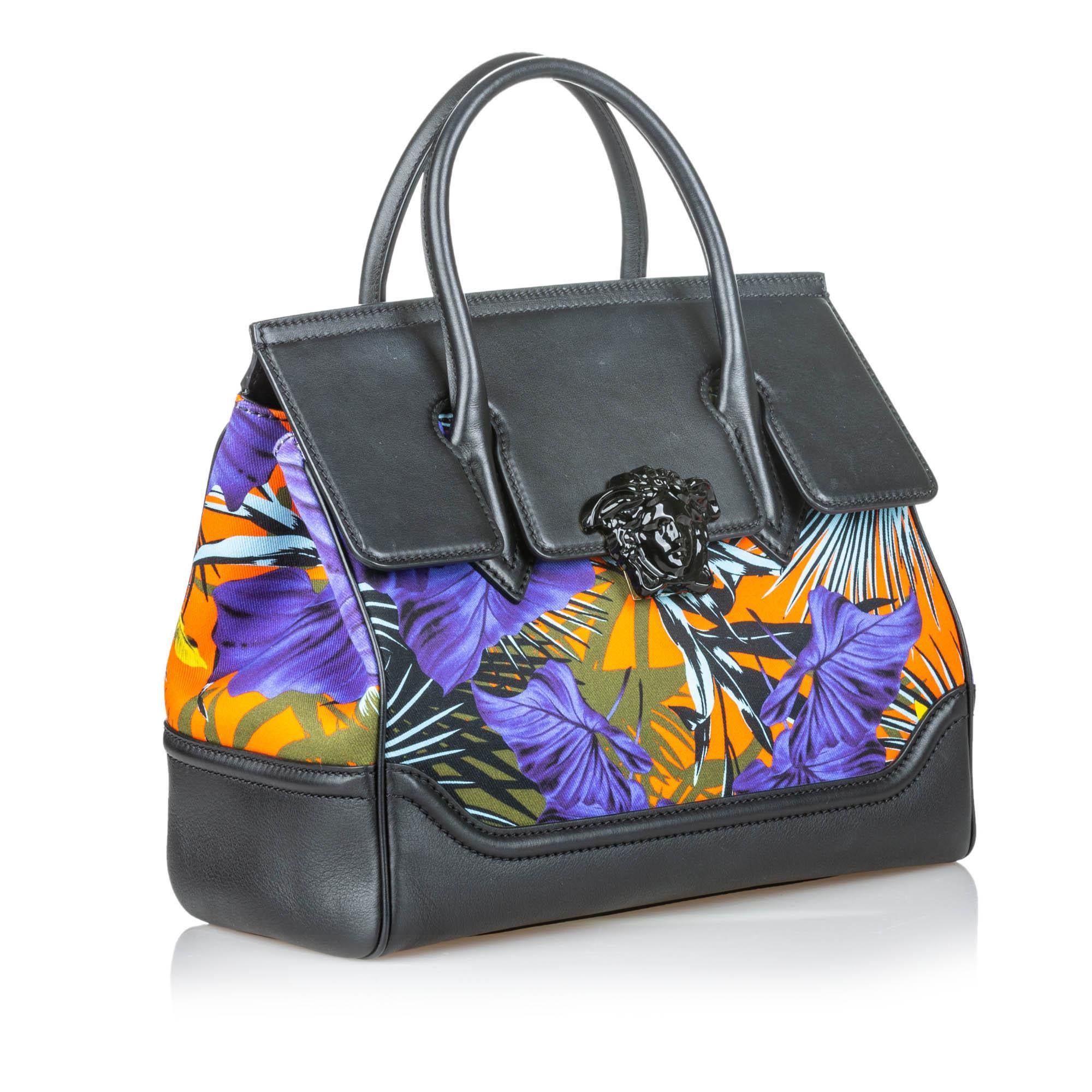 Versace Printed Canvas Palazzo Empire Satchel

The Palazzo Empire Satchel features a printed canvas body with leather trim, an adjustable flat leather strap, rolled leather handles, a front flap with a metal closure, and interior zip and slip