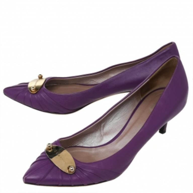 This pair of chic pumps by Versace is the standard of sophistication. It is designed from leather, with utmost precision. These pumps are supported with leather on the insides and make a fashionable and comfortable fit.  This pair of purple pumps