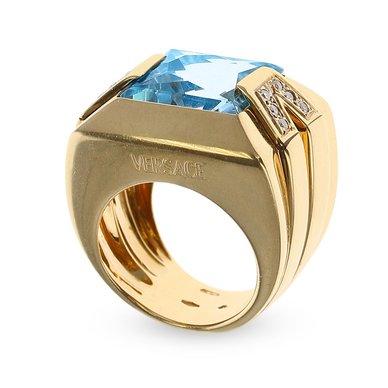 A bold Versace Rectangular Blue Topaz and Diamond Cocktail Ring made in 18K Yellow Gold. The Blue Topaz measures 12.50MM x 13.50MM
The Ring Size is US 6.50. The total weight of the ring is 20.31 grams. Stamped VERSACE.  