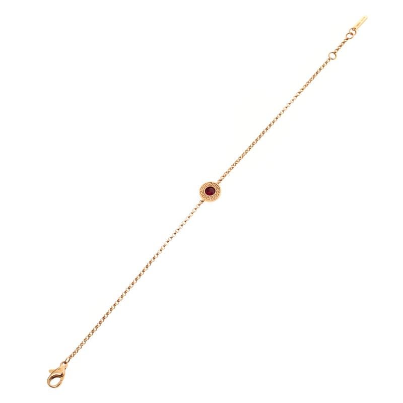 Artfully made from 18k rose gold, this flawless Soft bracelet by Versace can be your next prized possession. Featuring a gorgeous signature-engraved coin charm enhanced with a little red gemstone, the design has been finished with a lobster clasp.