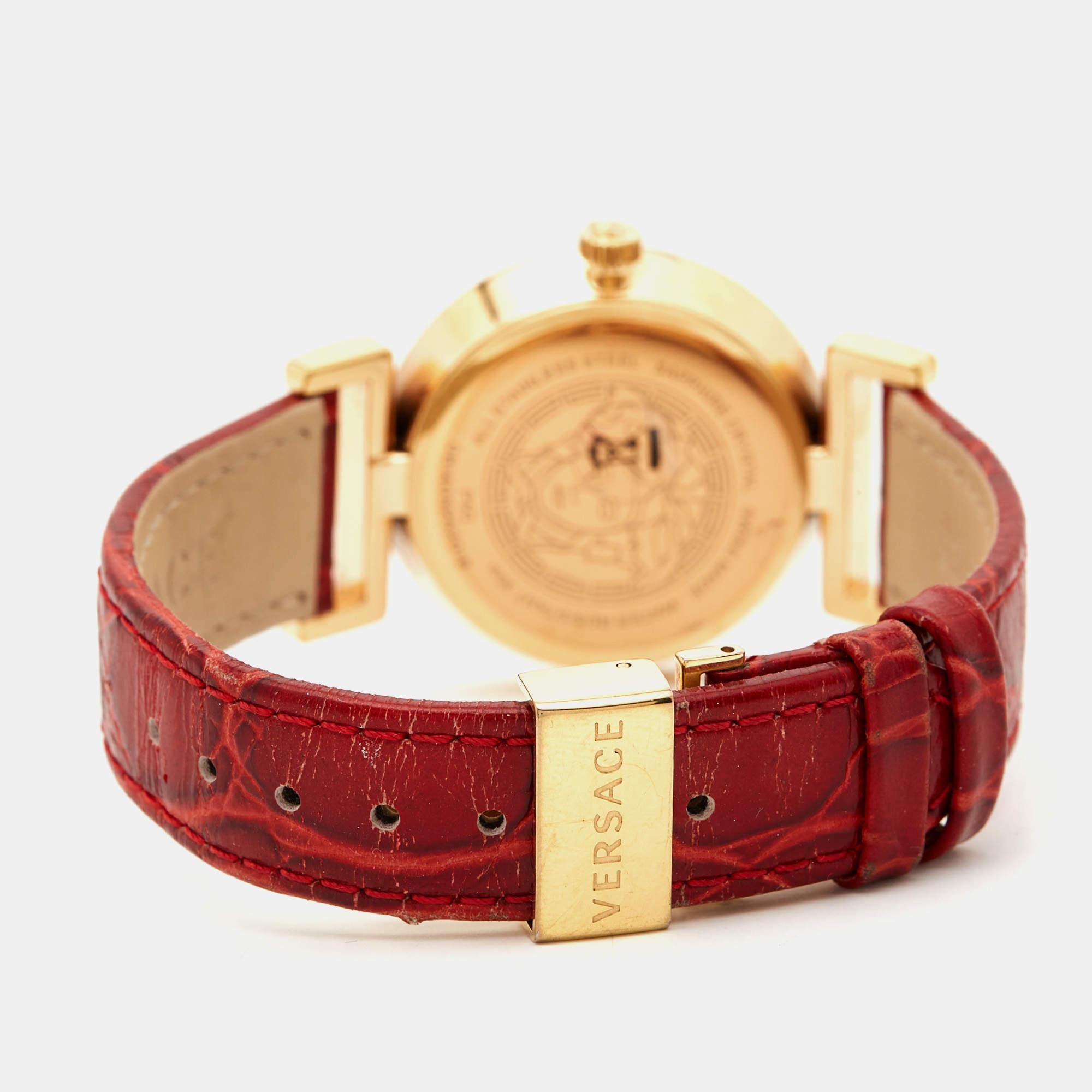 Accessorize your wrist with this luxuriously designed Vanity wristwatch by Versace. It features a round gold-plated stainless steel case and a riveted bezel. The watch has a red dial with studs for hour markers. It fixes on the wrist with a metal