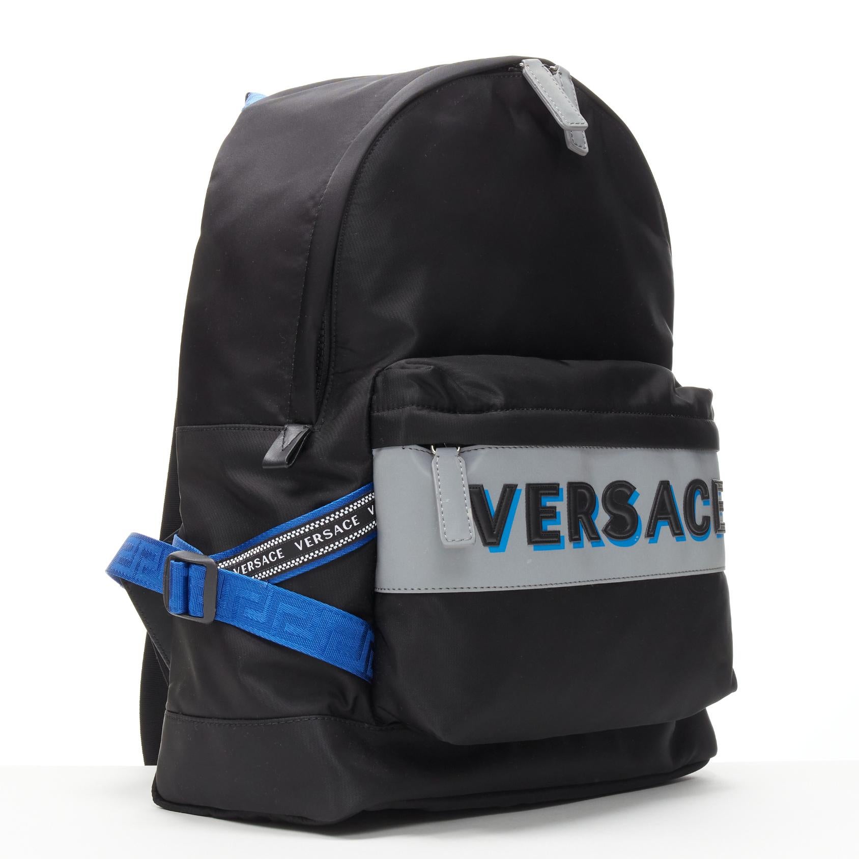 VERSACE Reflective Logo black nylon blue Greca nylon strap backpack
Reference: TGAS/C00868
Brand: Versace
Designer: Donatella Versace
Model: DFZ8069 DNY2R K046E
Material: Nylon
Color: Black, Silver
Pattern: Solid
Closure: Zip
Lining:  Nylon
Extra