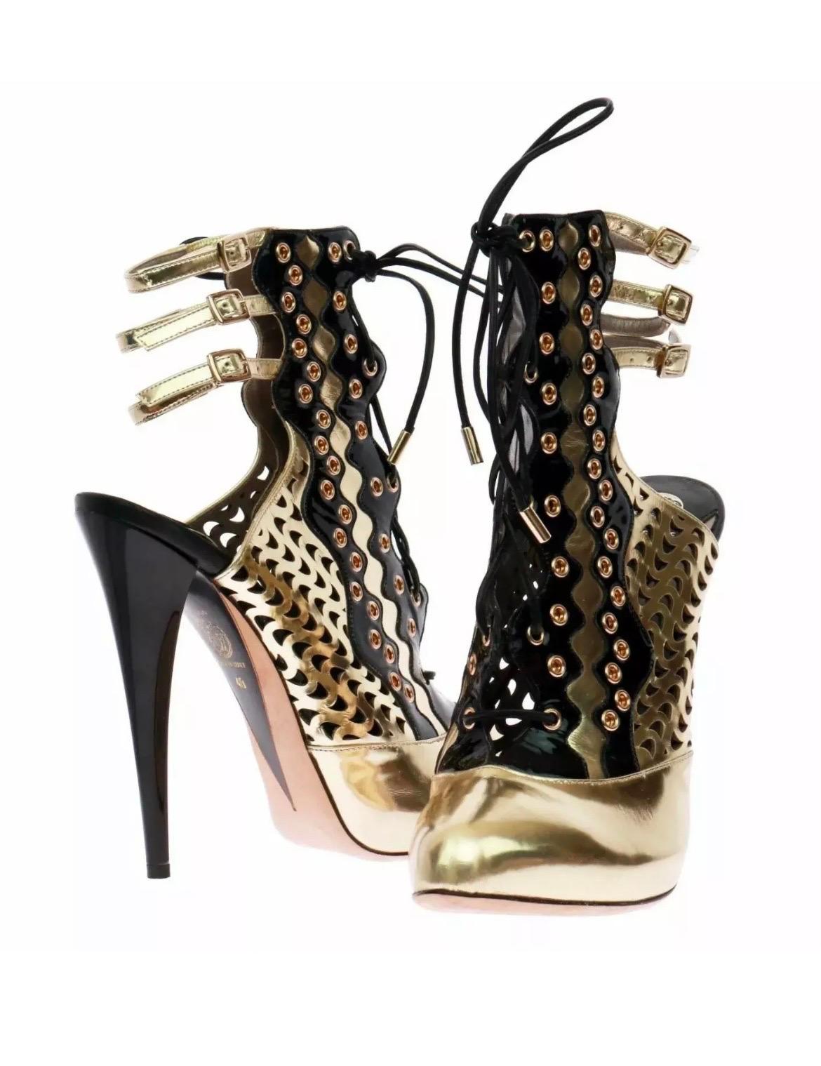 VERSACE Resort 2012 Gold Perforated Leather Ankle Boots
Size 40 (US 10)  Brand New 

A fierce and collectible runway creation from Versace’s Resort 2012 collection, these sculptural ankle boots are a fusion of glamour, art, and avant-garde