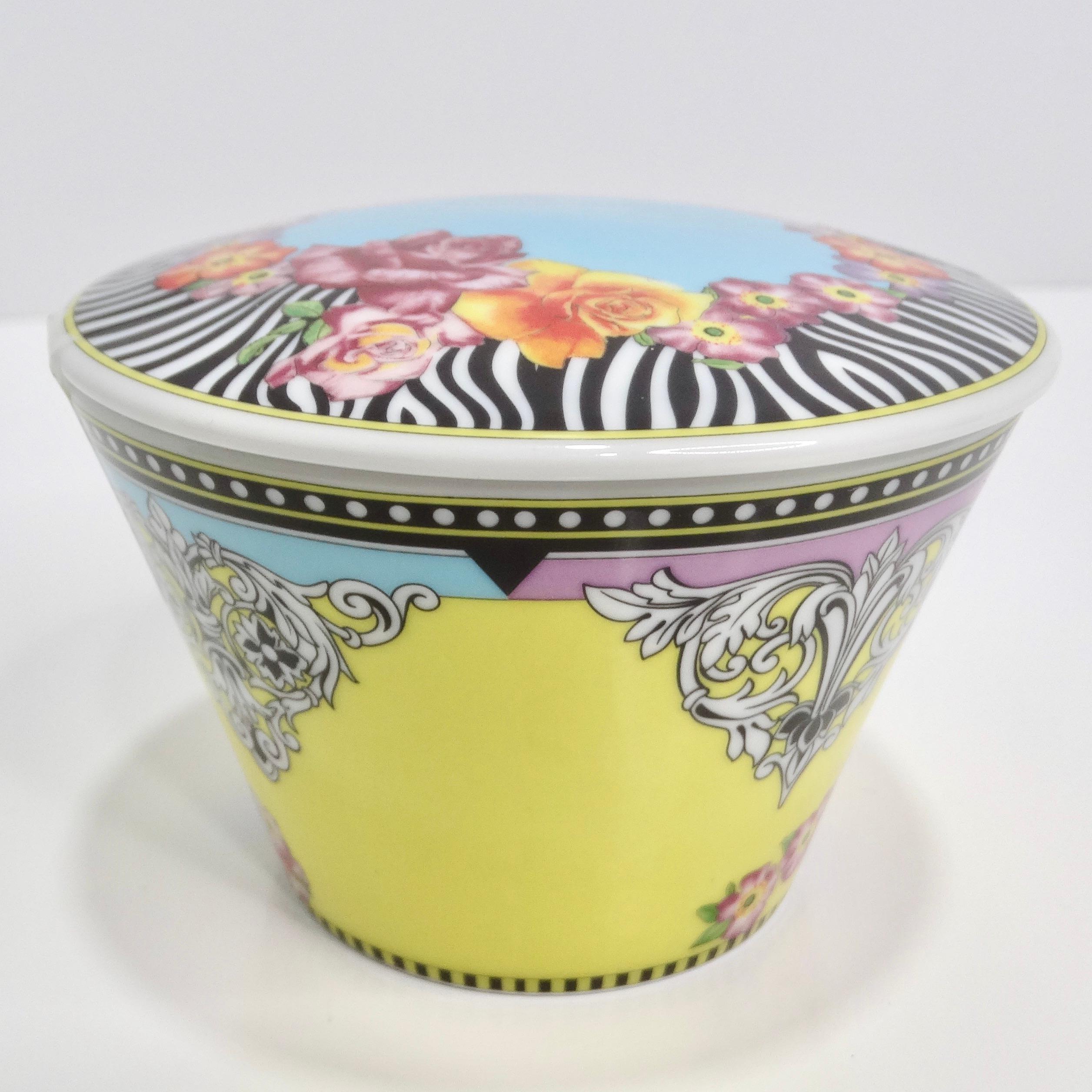 Indulge in the luxurious charm of the Versace Rosenthal 1990s Porcelain Sugar Bowl & Lid, a stunning addition to your barware that effortlessly combines whimsy with sophistication. Crafted from high-quality porcelain, this sugar bowl showcases a