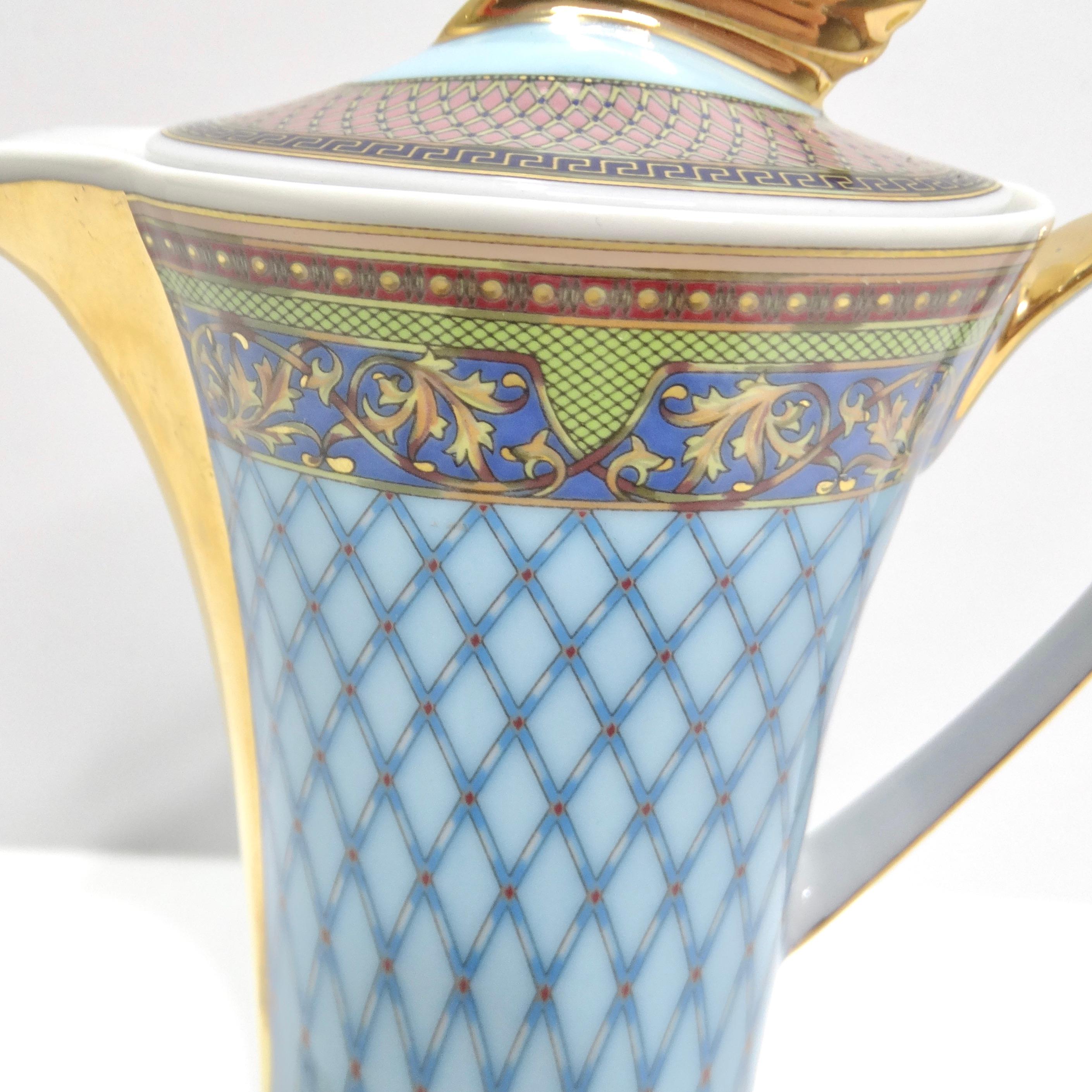 Introducing the Versace Rosenthal 1990s Russian Dream Coffee Pot – a stunning porcelain masterpiece that seamlessly blends opulence and artistry to bring a touch of luxury to your kitchen. With its captivating blue 'Russian Dream' design and