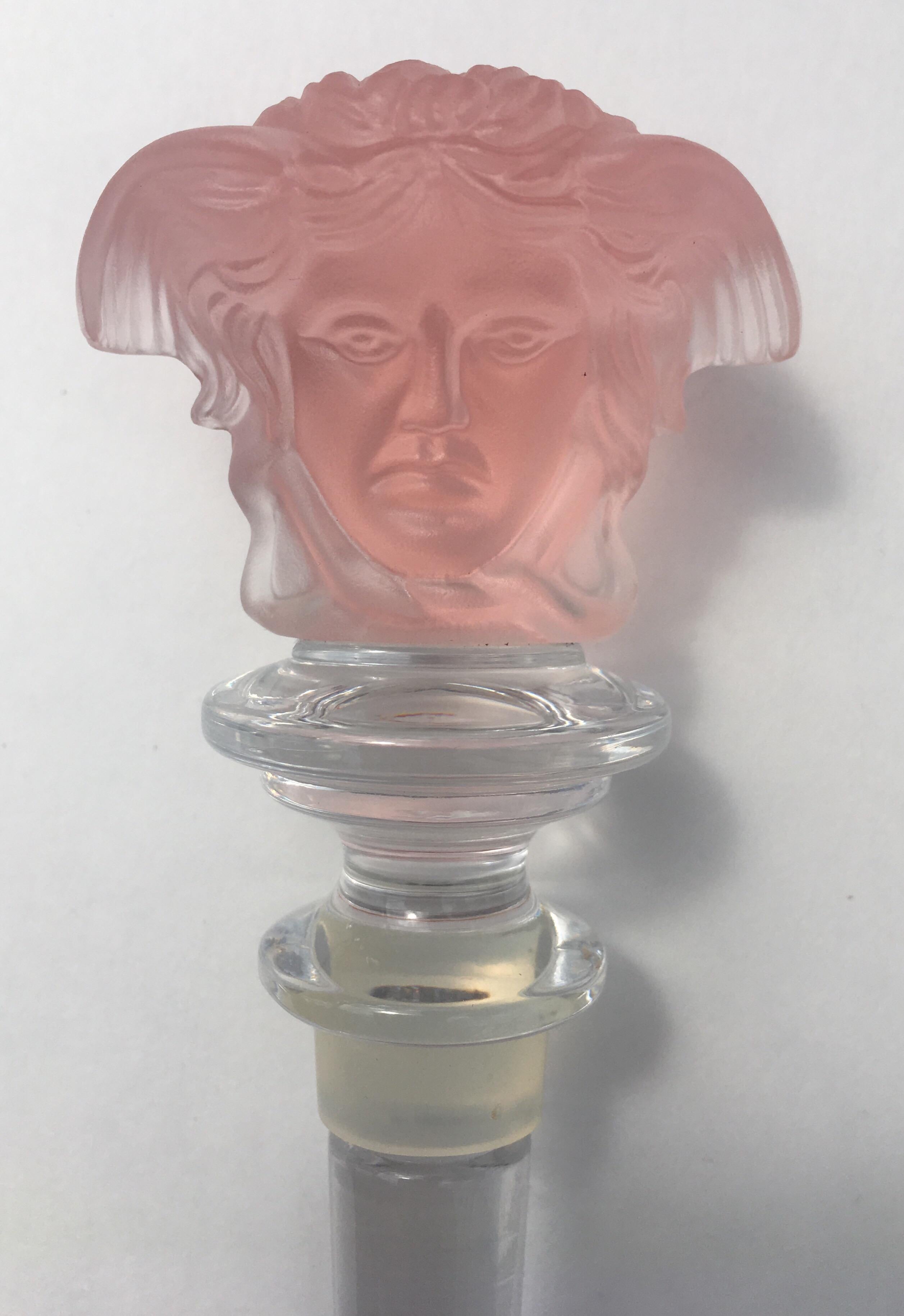 Etched carved pale rose/pink crystal wine decanter stopper by Versace for Rosenthal. Iconic Versace Medusa head on both sides of stopper. Original black and gold Greek key motif box. This beautiful bar accessory is marked “Rosenthal” “Versace”. Made