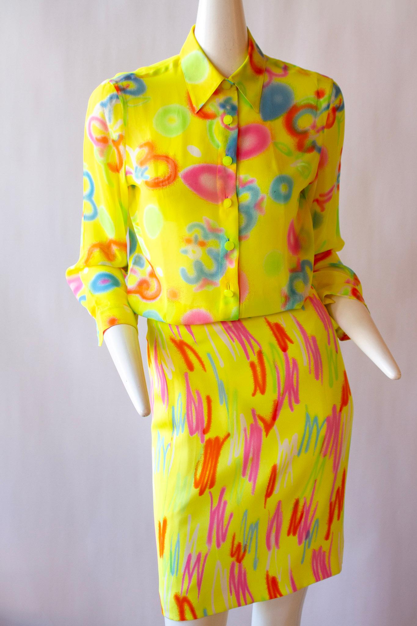 Neon hued skirt suit by Gianni Versace Couture which featured in the Spring 1996 ready-to-wear collection. Both the jacket and the dress are made using a beautifully soft silk, in a striking abstract design against a yellow background. The design