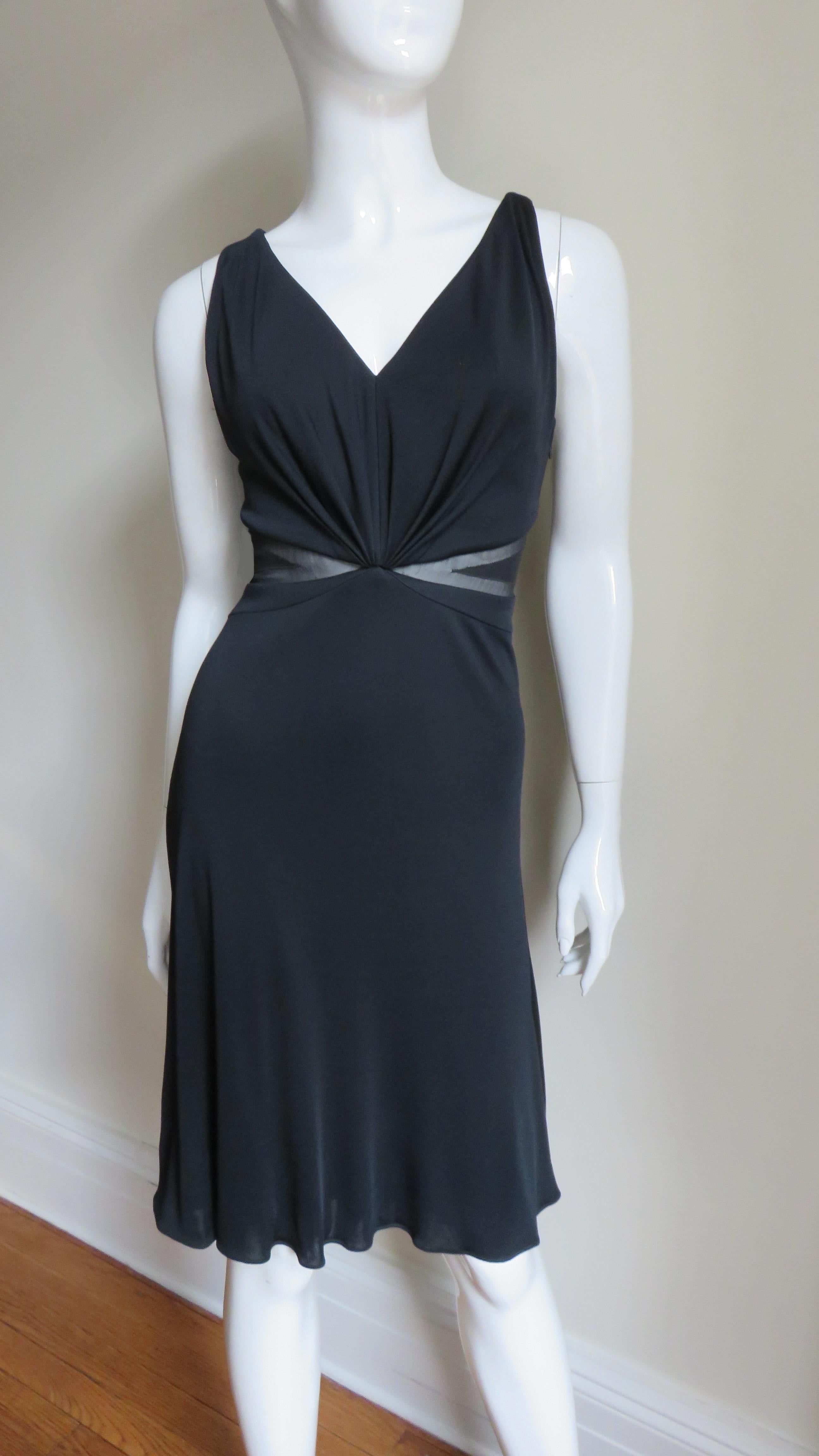 A beautiful black fine stretch silk dress from Versace. It is sleeveless with a V neckline front and back plus 1/2