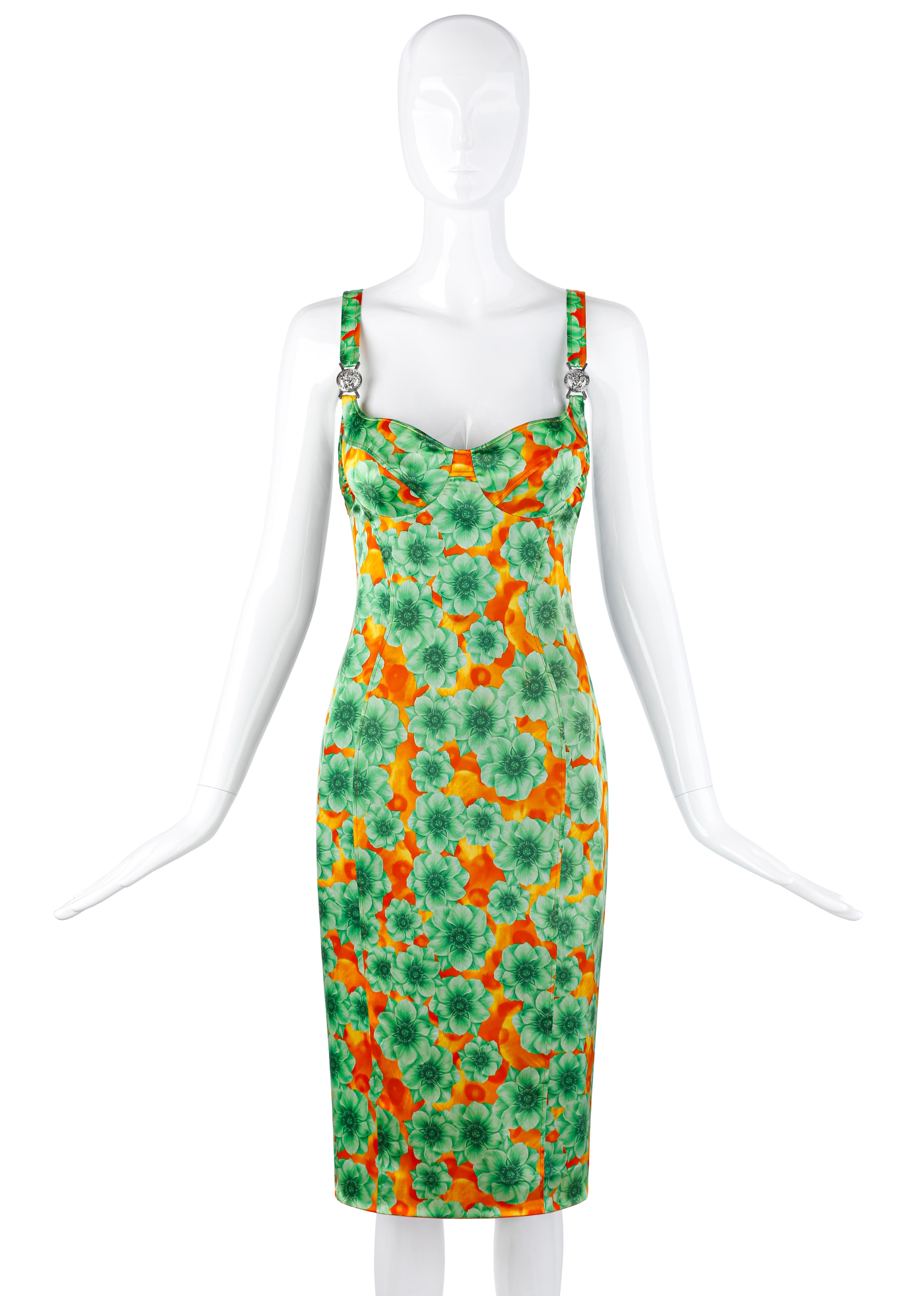 Designed by Donatella Versace circa early 2000's. Vibrant color palette of overlapping green and orange tones. Graphic floral print is collaged as visual art and includes larger green flowers in forefront with orange flowers in the background;