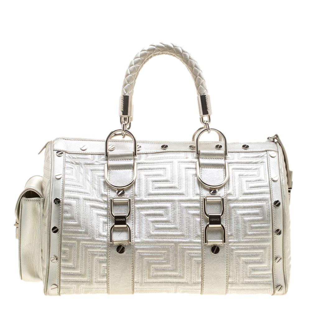 This bold and eye-catching Versace Snap Out Of It satchel is sure to make heads turn. Crafted from silver quilted leather, the bag is accented with a Gianni Versace Couture plate and silver-tone studded hardware. It features dual top braided