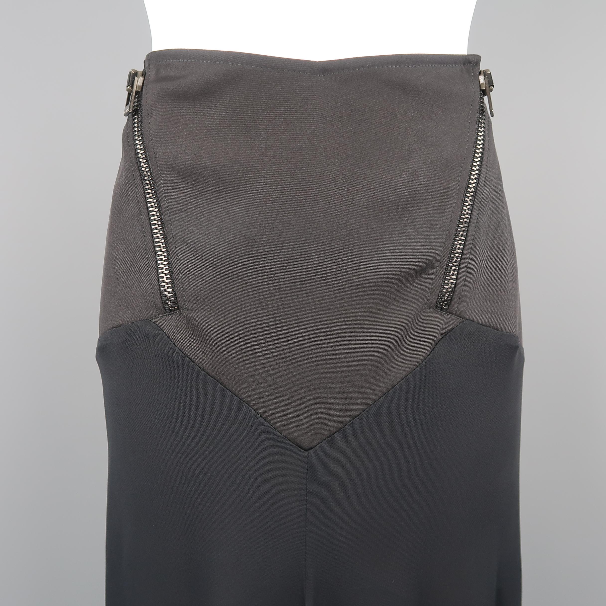 VERSACE skirt features a diagonal zip accented fitted top and layered flair silhouette ruffled hem bottom with slit. Made in Italy.
 
Excellent Pre-Owned Condition.
Marked: IT 44
 
Measurements:
 
Waist: 32 in.
Hip: 38 in.
Length: 23-28 in.
