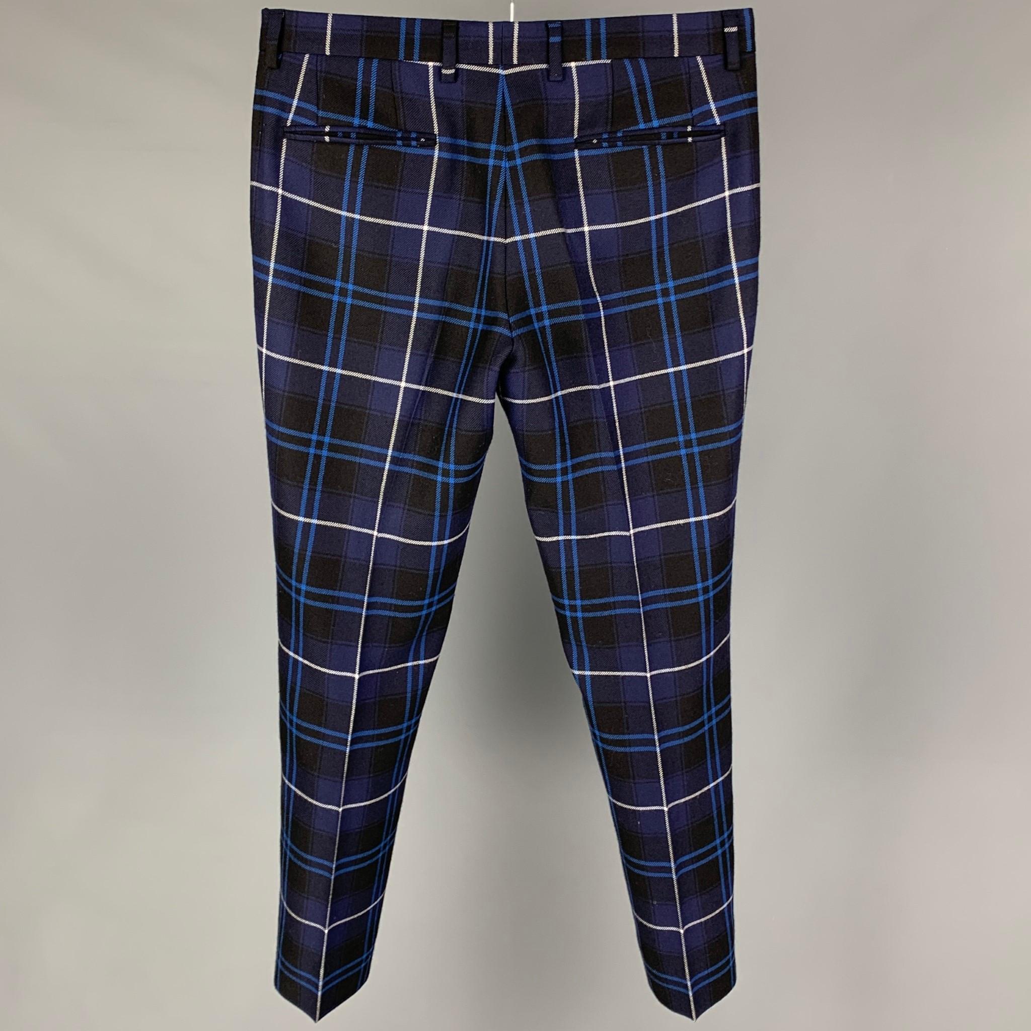 VERSACE dress pants comes in a navy & black plaid wool featuring a flat front and a zip fly closure. Made in Italy. 

Excellent Pre-Owned Condition.
Marked: 48

Measurements:

Waist: 33 in.
Rise: 9.5 in.
Inseam: 30 in.