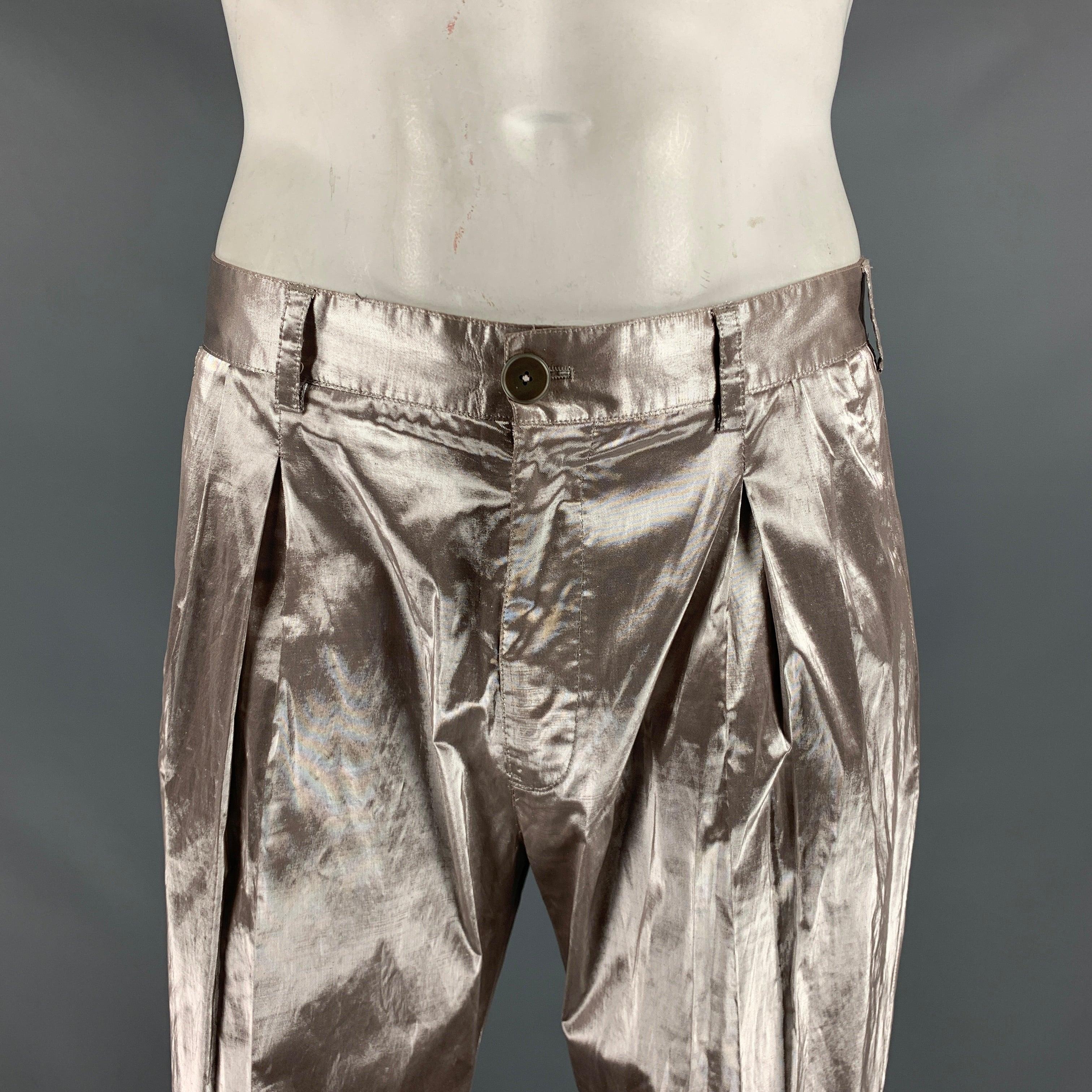 VERSACE dress pants comes in a silver metallic woven material featuring a unhemmed front pleated design and a zipper fly closure. Made in Italy.Excellent Pre- Owned Condition. 

Marked:   34 

Measurements: 
  Waist: 34 inches Rise: 10.5 inches