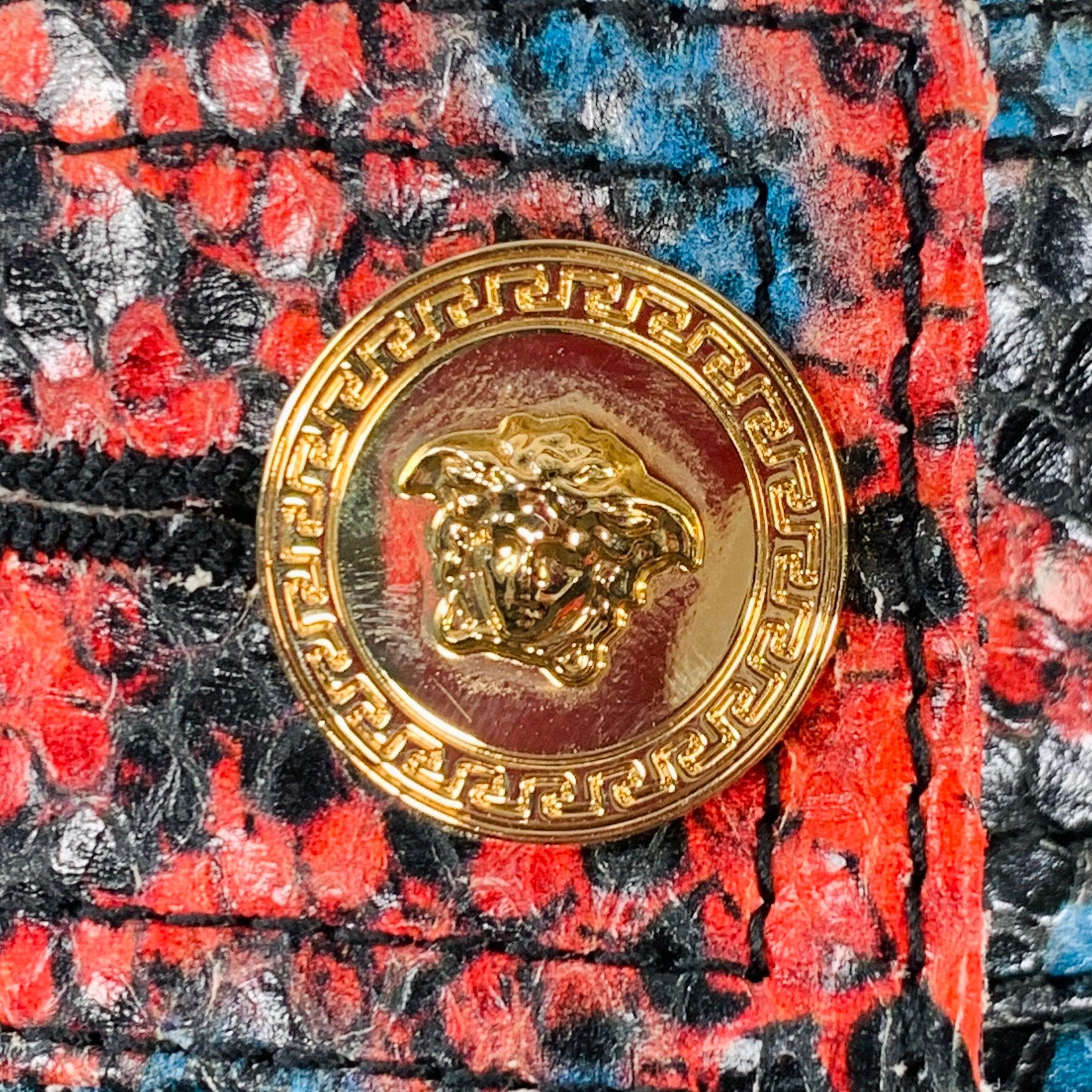 VERSACE skirt
in a red and blue snake embossed leather featuring a pencil style, four pockets, and button closure with gold tone metal Medusa's head buttons.Very Good Pre-Owned Condition. Minor creasing, which is hard to see due to pattern.