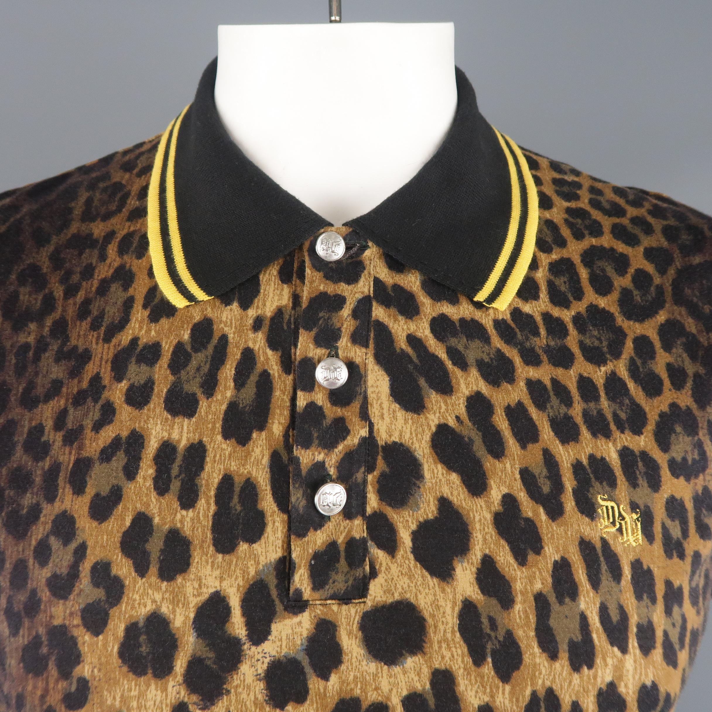 VERSACE polo shirt comes in brown leopard print jersey with a gold baroque print trim, silver tone engraved buttons, and black and yellow striped collar and trim. Made in Italy.
 
Excellent Pre-Owned Condition.
Marked: IT 56
 
Measurements:

