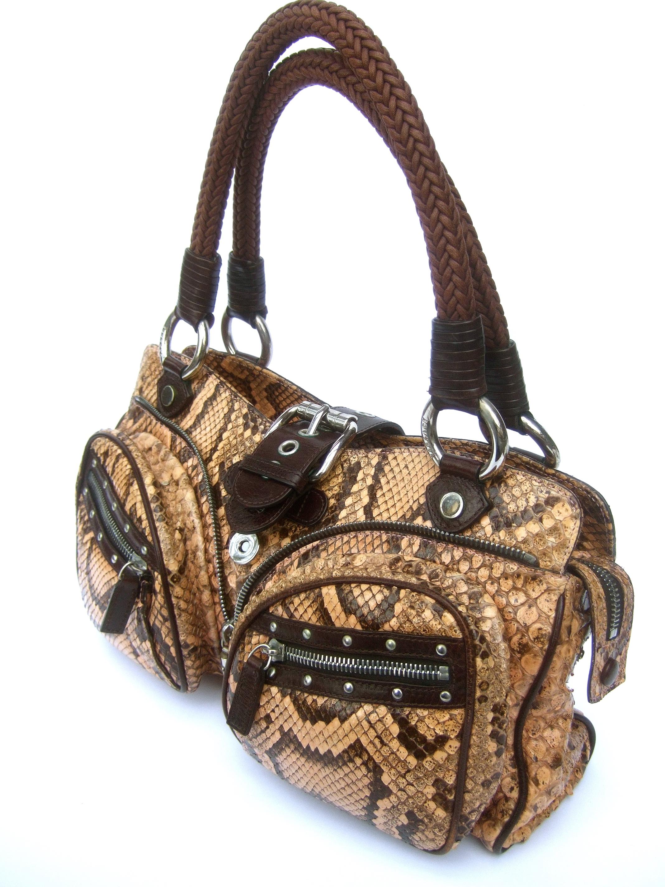 Versace Exotic snakeskin leather trim handbag c 1990s
The stylish Italian handbag is constructed with snakeskin
 Accented with two zippered pouch compartments 
on the front exterior

Designed with a brown leather silver buckle snap clasp mechanism