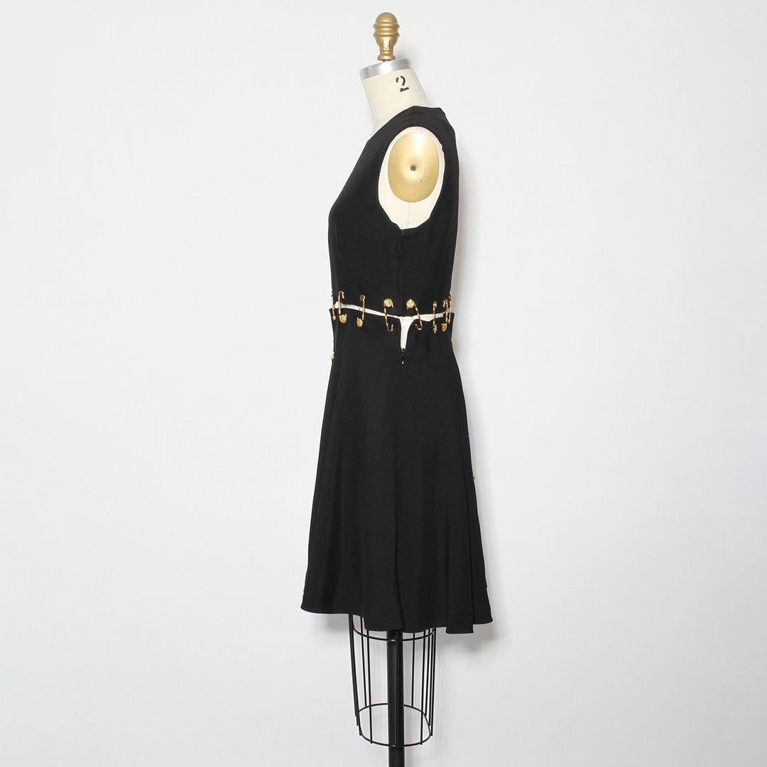 From the Iconic Spring Collection of 1994, this lifetime Gianni Versace safety pin mini dress is a prime example of the designer's house elements and the spirit of the early-mid 1990s. The sexy proportions of the minimal silhouette and shorter