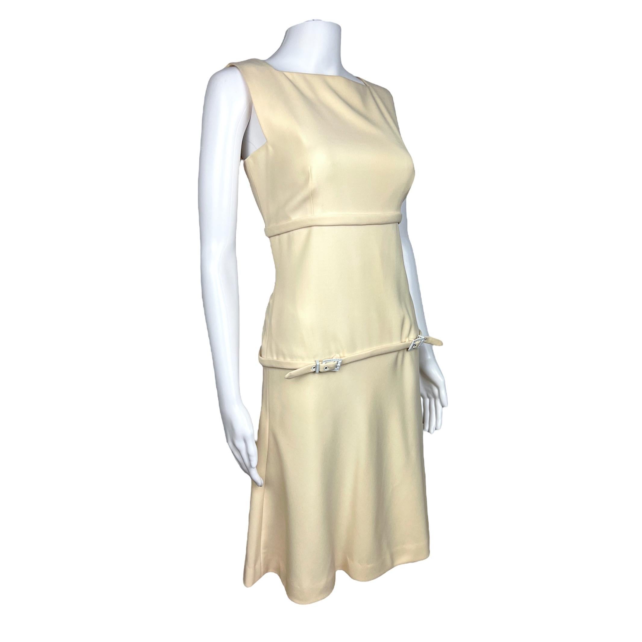 Beautiful Gianni Versace Couture 60s inspired cream dress from Spring Summer 1996 collection. The dress is knee length, with thin adjustable belts including classic Versace Areca pattern details on the hardware and classic Versace medusa head logo