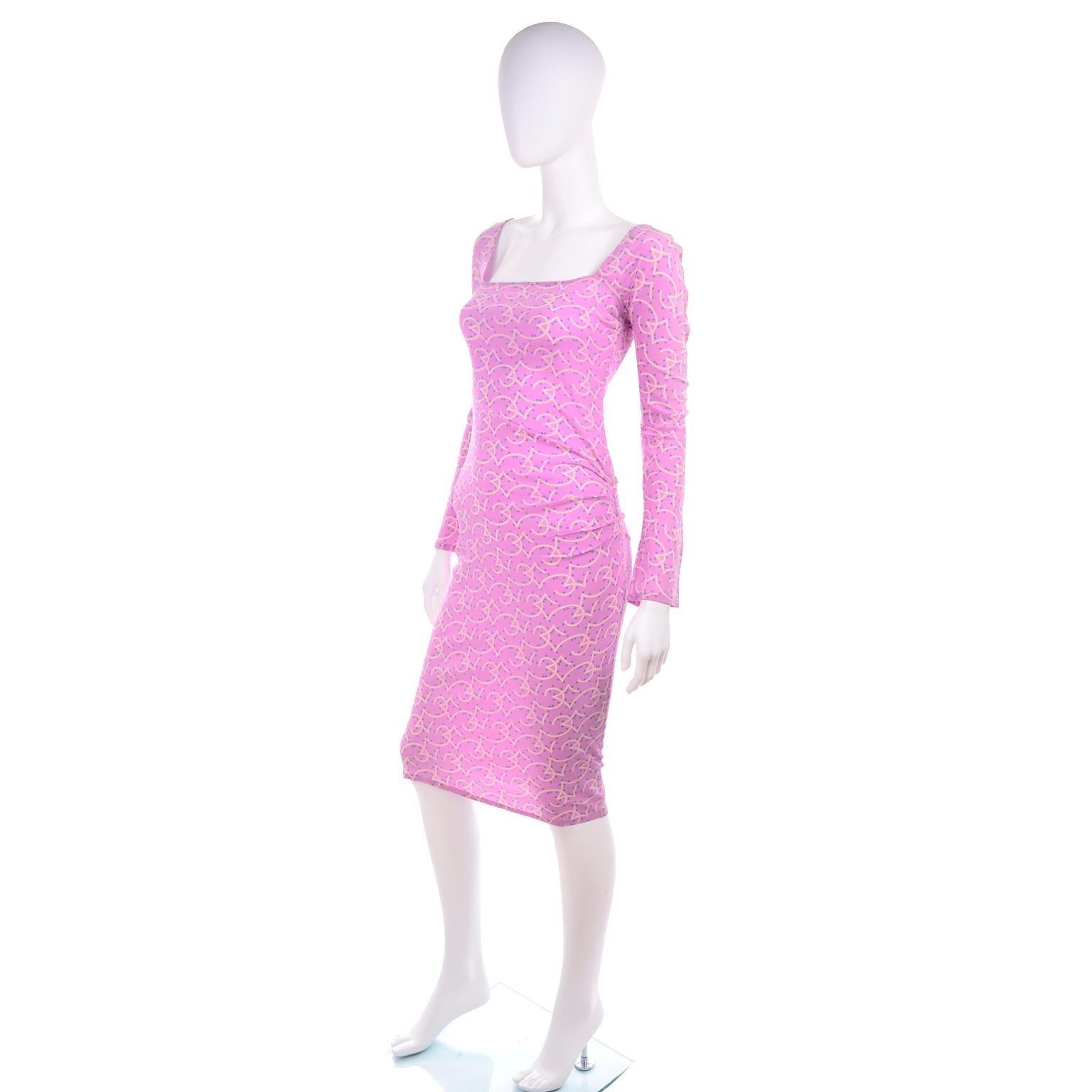 This is a Gianni Versace documented 1998 Runway Dress in a delicate purple and pink silk with cream geometry cloud like shapes and tiny blue stars . The dress has a square neckline and the left portion of waist and hips has pleat like ruching that