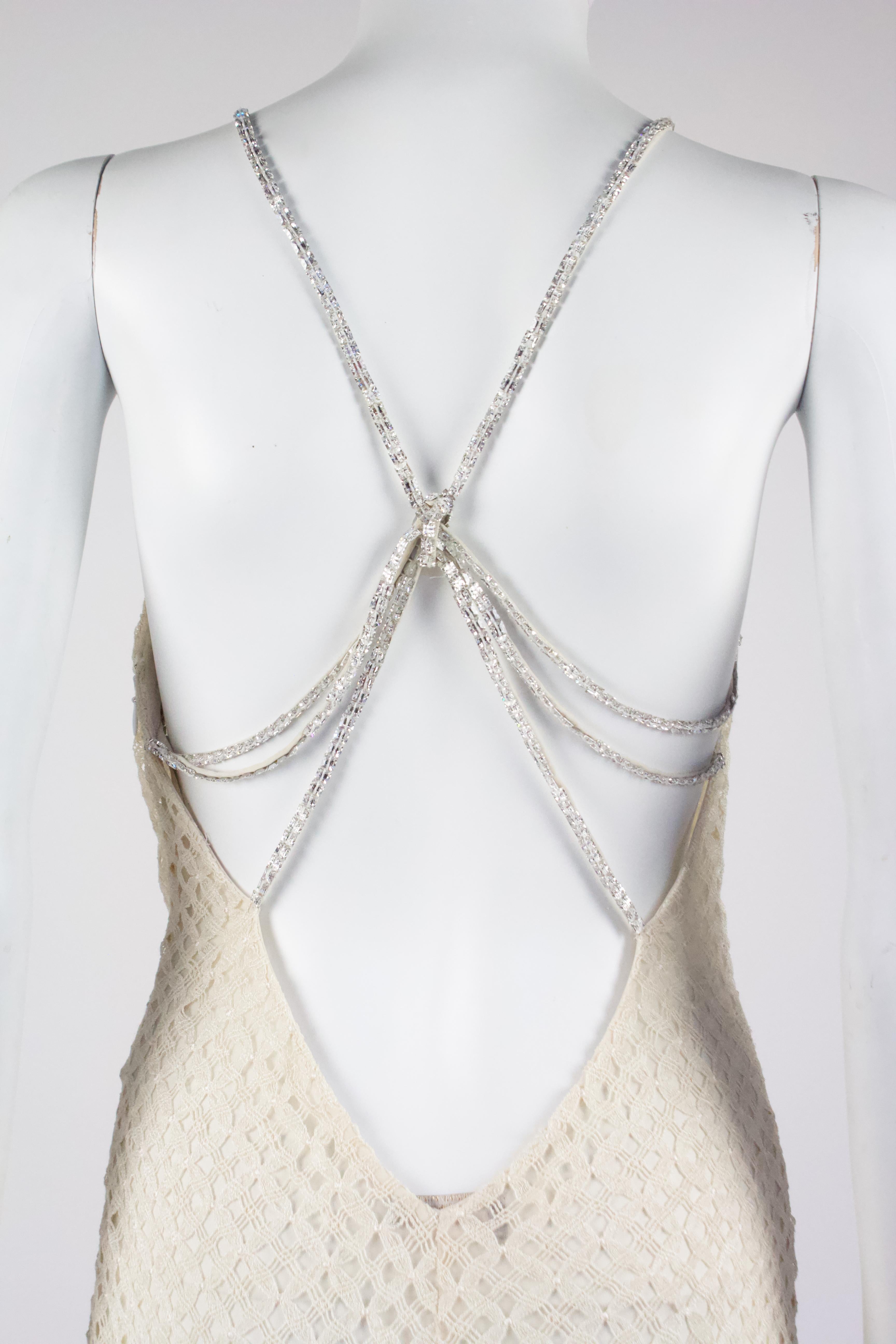 Gianni Versace ivory knitted dress, with diamante chain strap detail on the back, from the Spring/Summer 2002 collection by Donatella Versace

Condition
Excellent 

Marked Size
IT 42

Approximate Measurements
Bust: 32-34