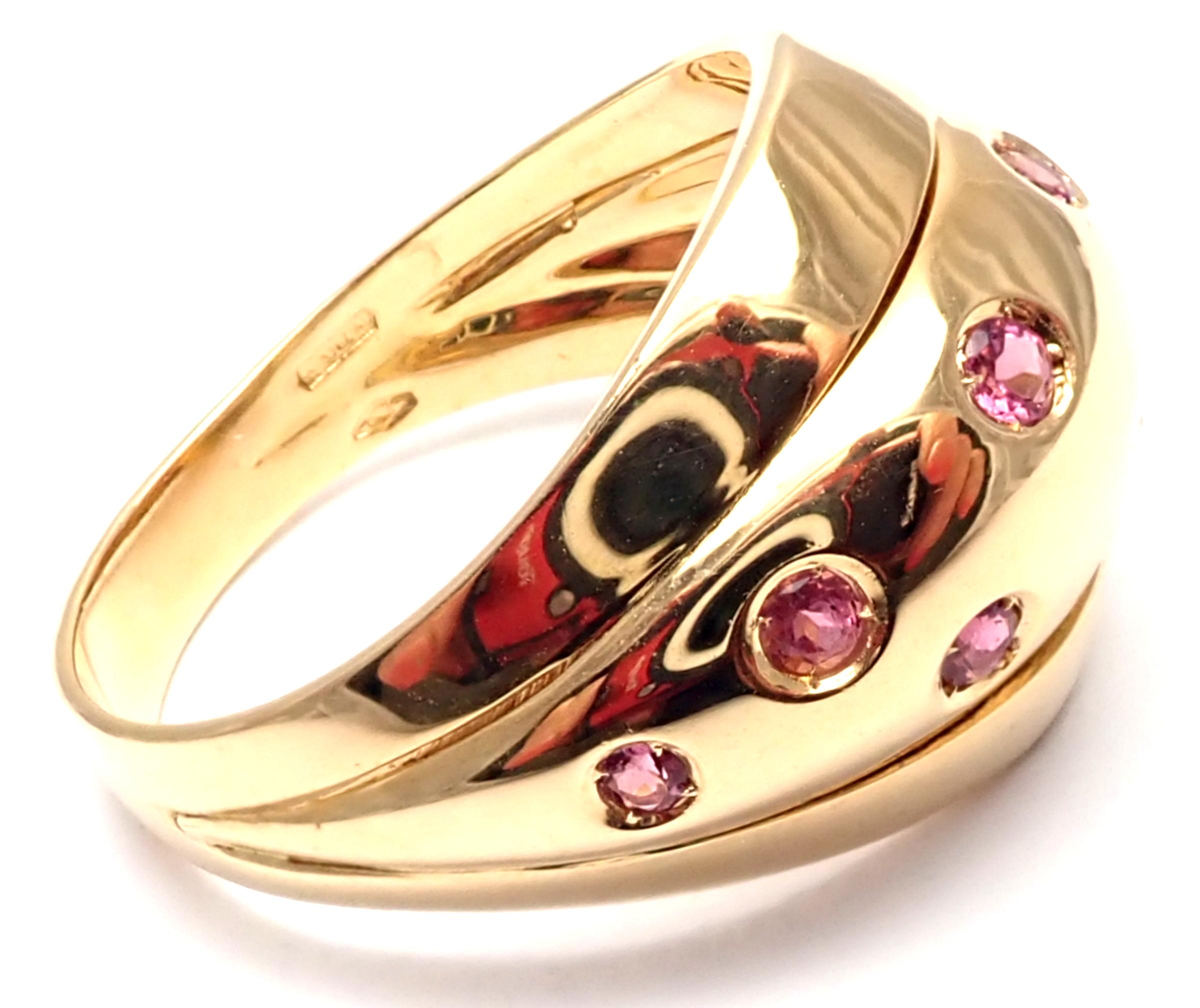 18k Yellow Gold Pink Sapphire Ring By Versace.
With 9 pink sapphires.
Details: 
Size: Size 7 1/2
Width: 16mm to 4mm 
Weight: 8.4 grams
Stamped Hallmarks: Versace 750 Made in Italy
*Free Shipping within the United States* 
Your Price: $2,900
Retail