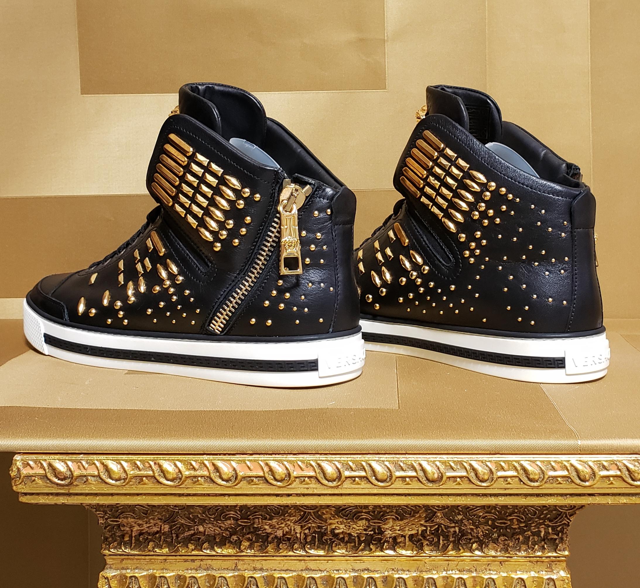 VERSACE 

SOLD OUT!!!

NEW VERSACE STUDDED HIGH-TOP SNEAKERS with GOLD MEDUSA BUCKLE and GOLD side ZIPPER 
  
This shoe is embodied in true Versace-style and  features a great mix of black  smooth leathers with gold-tone accents.  
Gold-tone studs