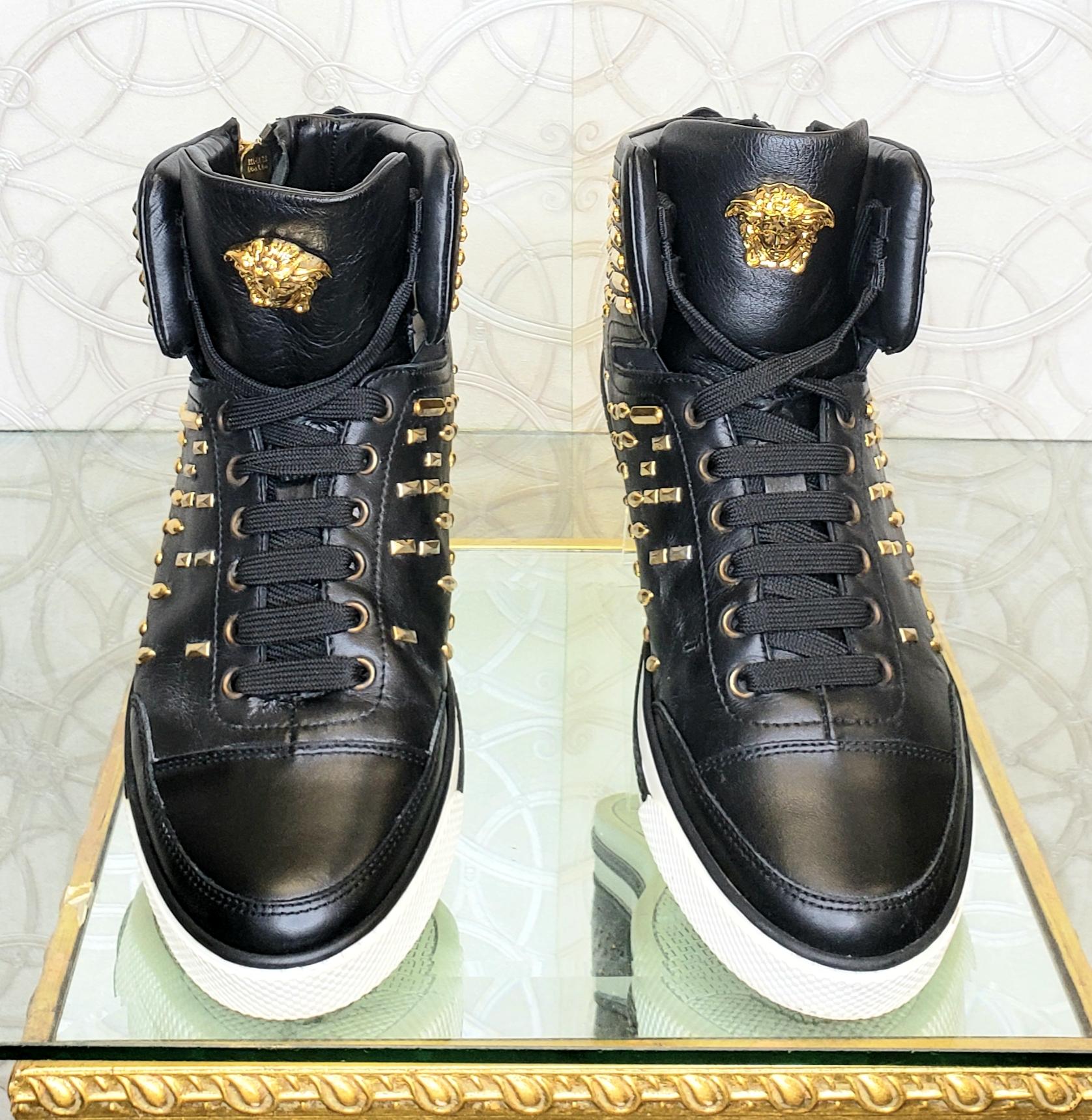 VERSACE 

SOLD OUT!!!

NEW VERSACE STUDDED HIGH-TOP SNEAKERS with GOLD MEDUSA BUCKLE and GOLD side ZIPPER 
  
This shoe is embodied in true Versace-style and  features a great mix of black  smooth leathers with gold-tone accents.  
Gold-tone studs