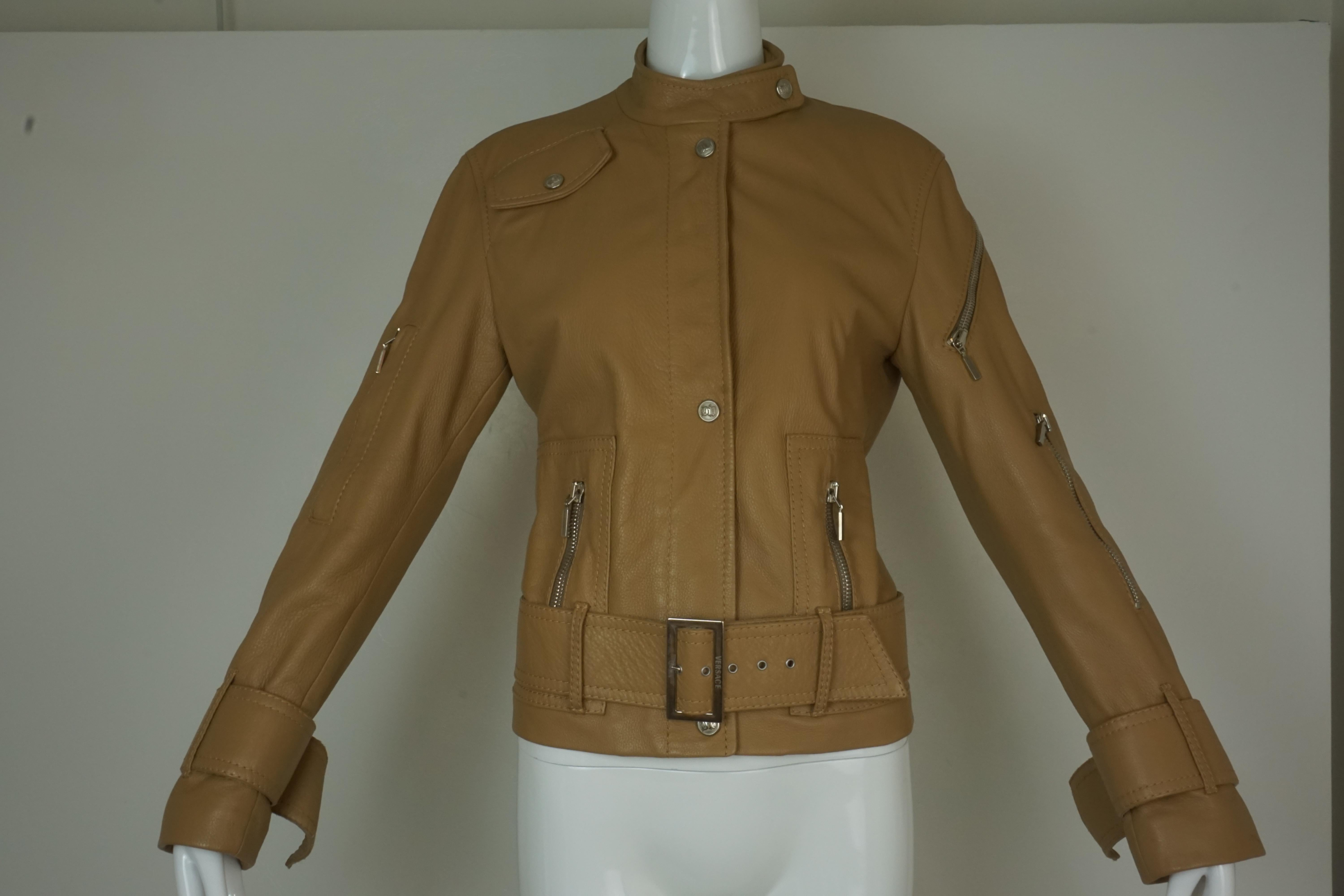Versace Studded Light Brown Leather Motorcycle Jacket. Classic motorcycle zipper and belting. Buckles at cuffs. Rayon lining. Size 6,  38