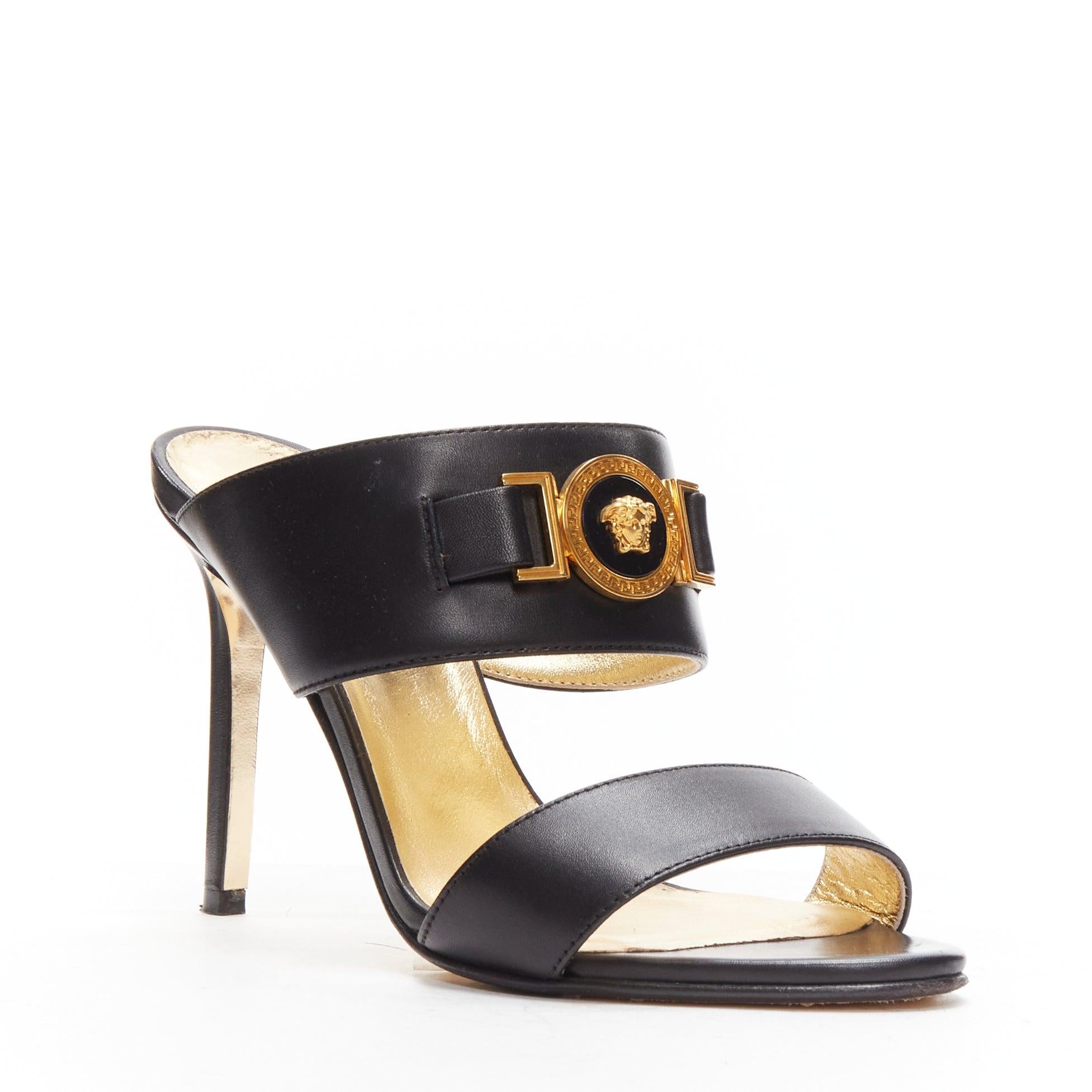 VERSACE Tribute gold Medusa buckle black double strap high heel mule sandals EU37
Reference: LNKO/A02169
Brand: Versace
Designer: Donatella Versace
Collection: Tribute
Material: Leather, Metal
Color: Black, Gold
Pattern: Solid
Closure: Slip
