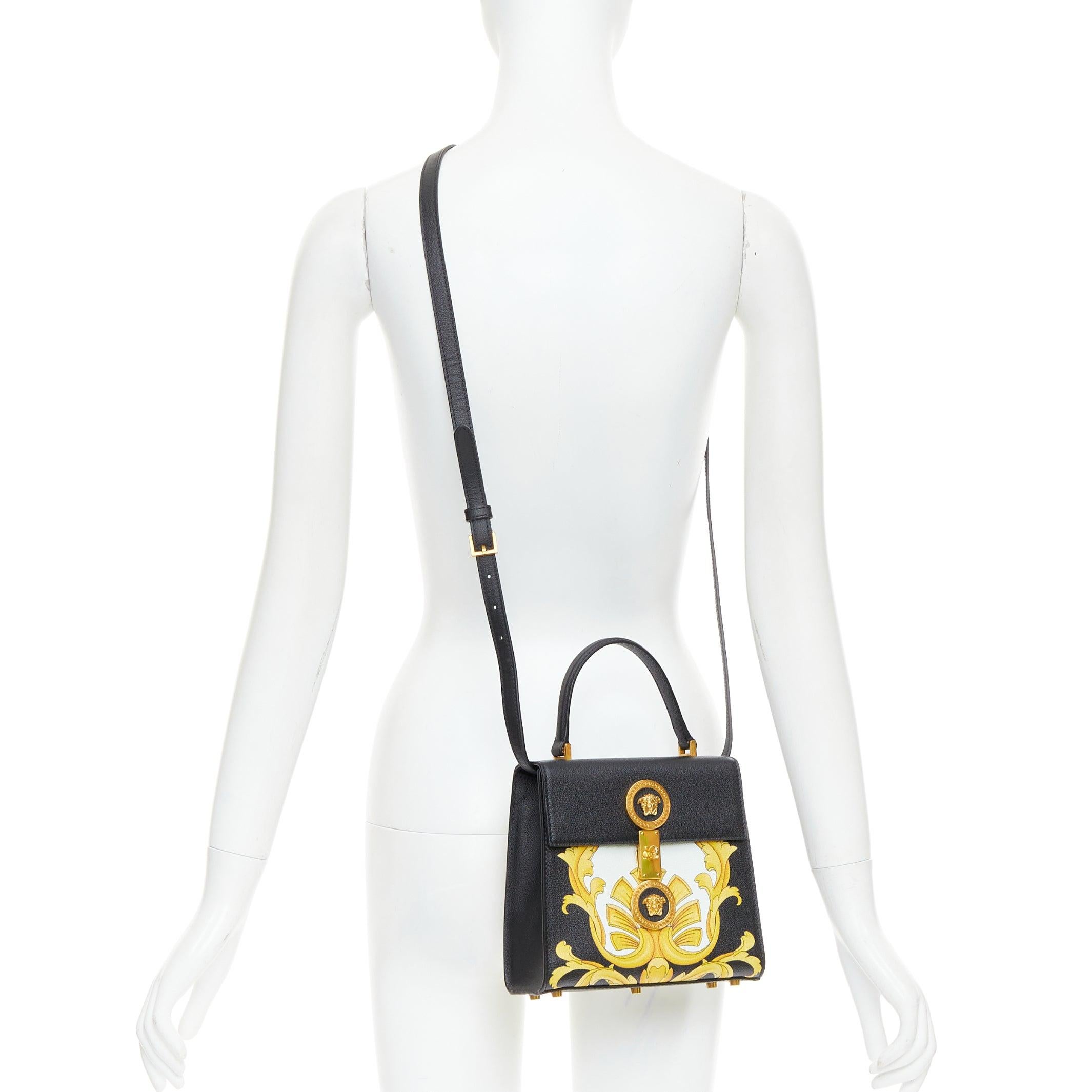 VERSACE Tribute Icon black gold Barocco calfskin Medusa crossbody satchel bag
Reference: TGAS/E00999
Brand: Versace
Designer: Donatella Versace
Material: Leather
Color: Black, Gold
Pattern: Barocco
Closure: Turnlock
Lining: Black Leather
Made in: