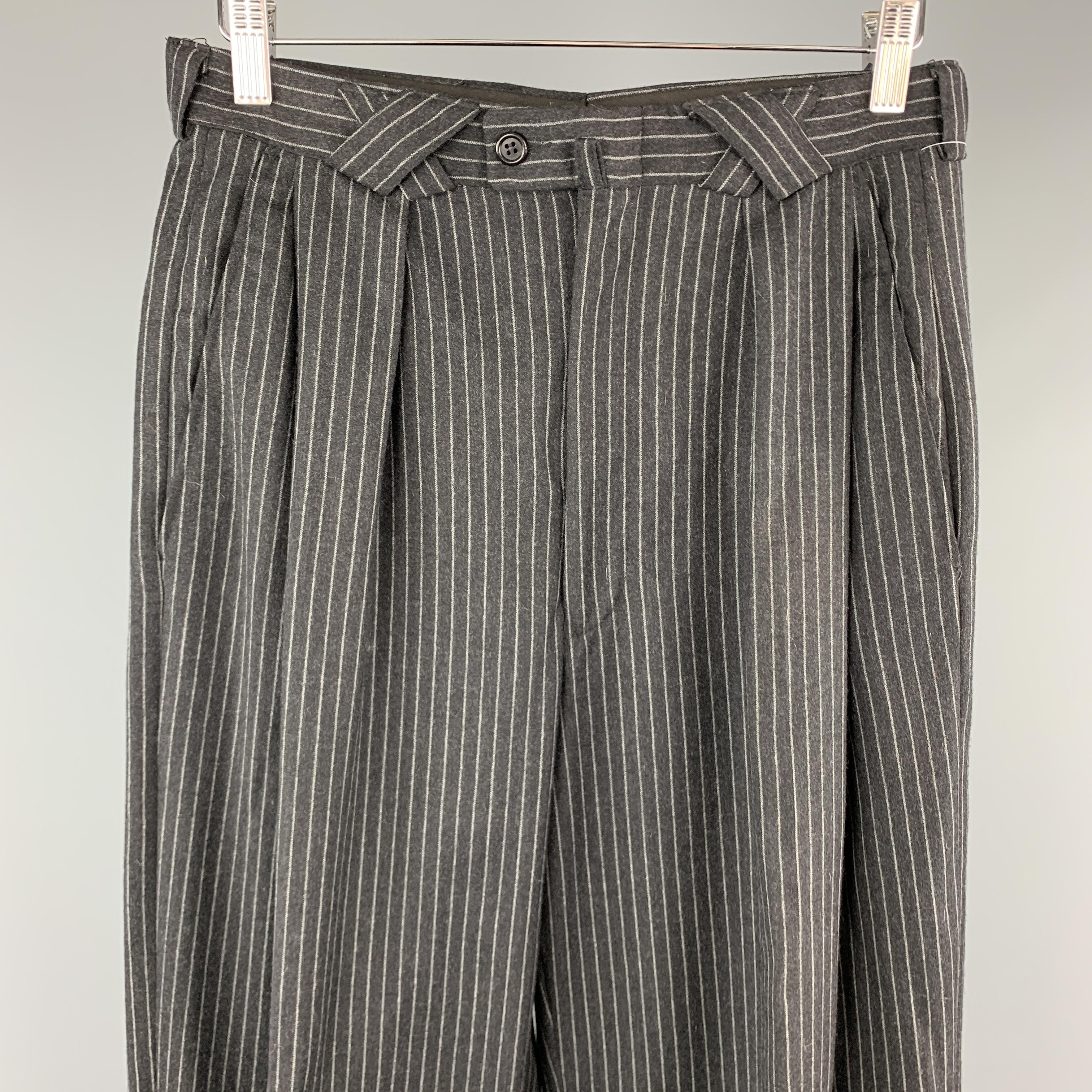 VERSACE CLASSIC V2 dress pants come in charcoal gray pinstriped wool with a x loop waistband, cuffed hem, and pleated wide leg. Made in Italy.

Excellent Pre-Owned Condition.
Marked: 32 R

Measurements:

Waist: 29 in.
Rise: 13 in.
Inseam: 29 in.
Leg