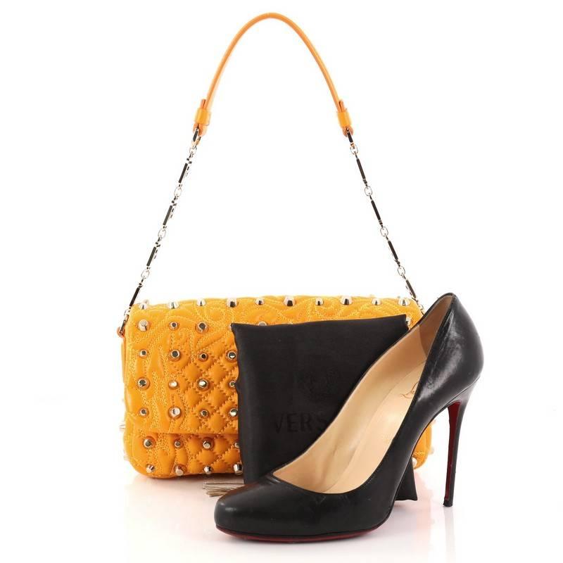 This authentic Versace Vanitas Medea Flap Bag Studded Barocco Leather exudes classic Versace styling with a modern twist perfect for your day or nights out. Constructed from studded Barocco yellow-orange quilted leather, this bag features shoulder