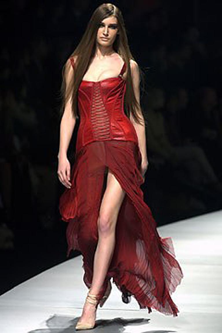 The Versace 2003 collection showcased high impact versions of the corset dress.   One version of which is this deep two-tone rich wine satin boned bodice enhanced by trappunto stitching;  extending into a long open panel silk chiffon skirt.   Side