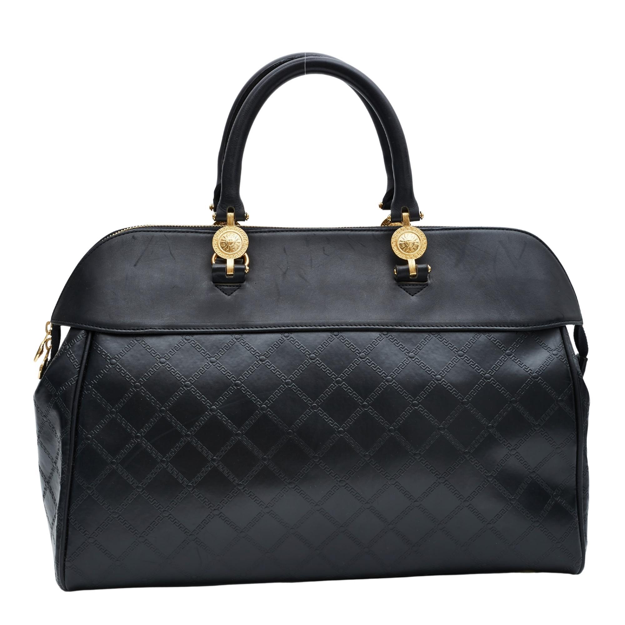 This vintage Versace bag is made with a smooth matte black leather superior part and a body of shiny motif embossed leather. The matte black leather and shiny motif embossed leather placed in juxtaposition to each other creates a luxurious effect.